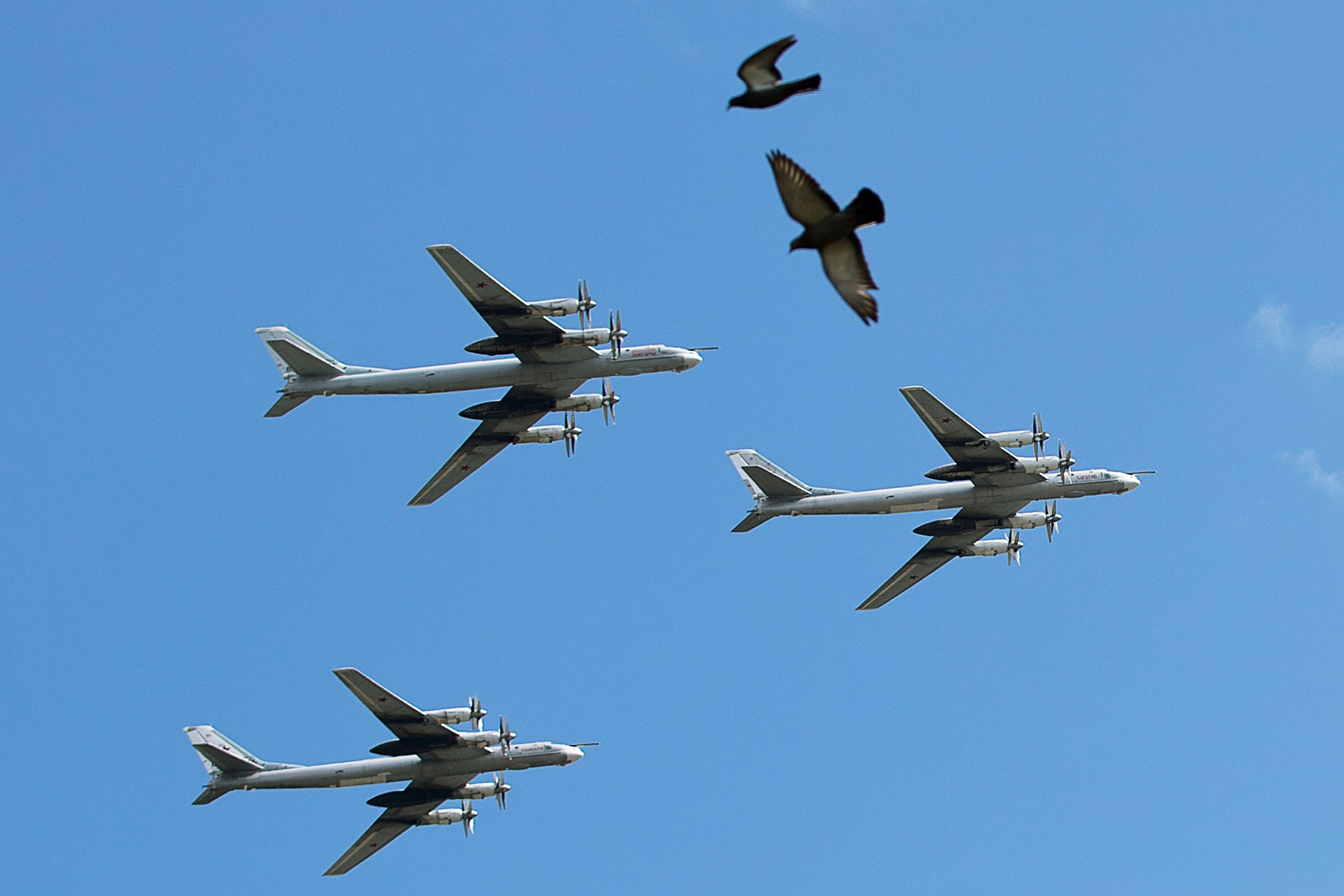 FILE - A trio of Tu-95 nuclear-capable strategic bombers of the Russian air force fly over Pushkin Square in Moscow, Russia, Saturday, May 3, 2014 during a rehearsal for the Victory Day military parade which will take place at Moscow's Red Square on May 9 to celebrate 69 years of the victory in WWII. (AP Photo/Pavel Golovkin, File)