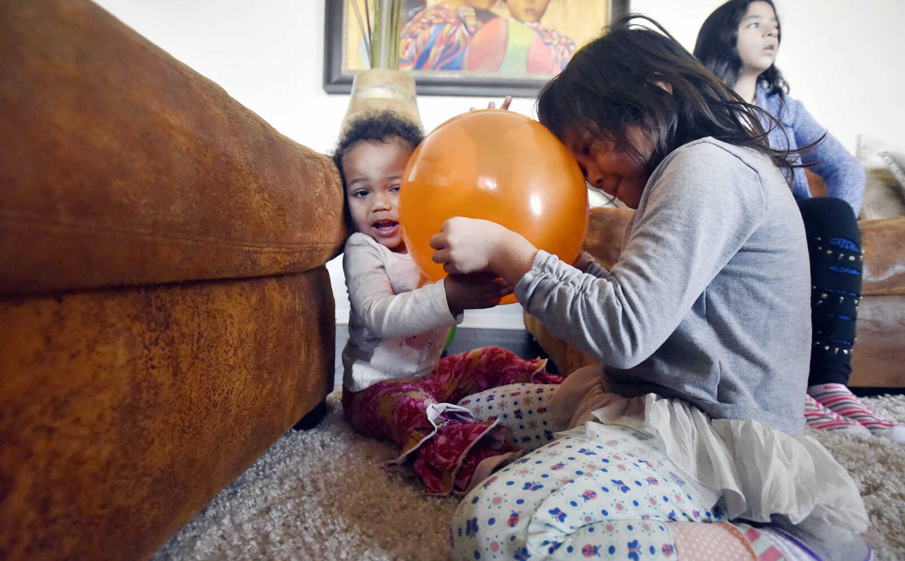 Ari Becking, 5, right, and her little sister Lennyx, 1, play with a balloon on Saturday, Jan. 28, 2017, at the Becking's Cape Girardeau home.