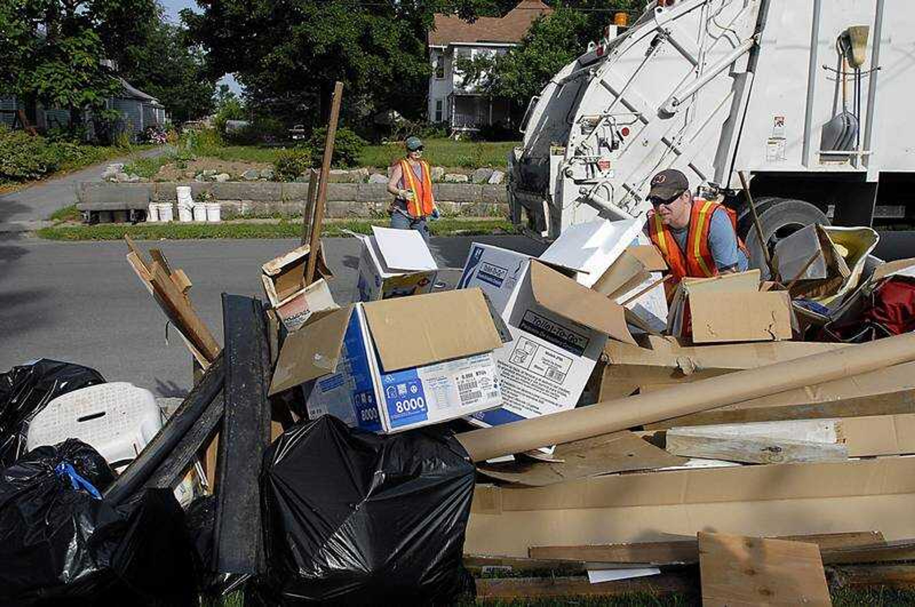 KIT DOYLE ~ kdoyle@semissourian.com
Bob and Callie Miller approached a heaping pile of trash to be tossed in the truck Thursday morning, June 26, 2008, while getting Knee Deep with the Jackson Sanitation Department. Trash collecting was especially difficult because of Jackson's annual Spring Cleaning Pickup when residents may put out as much trash as possible.