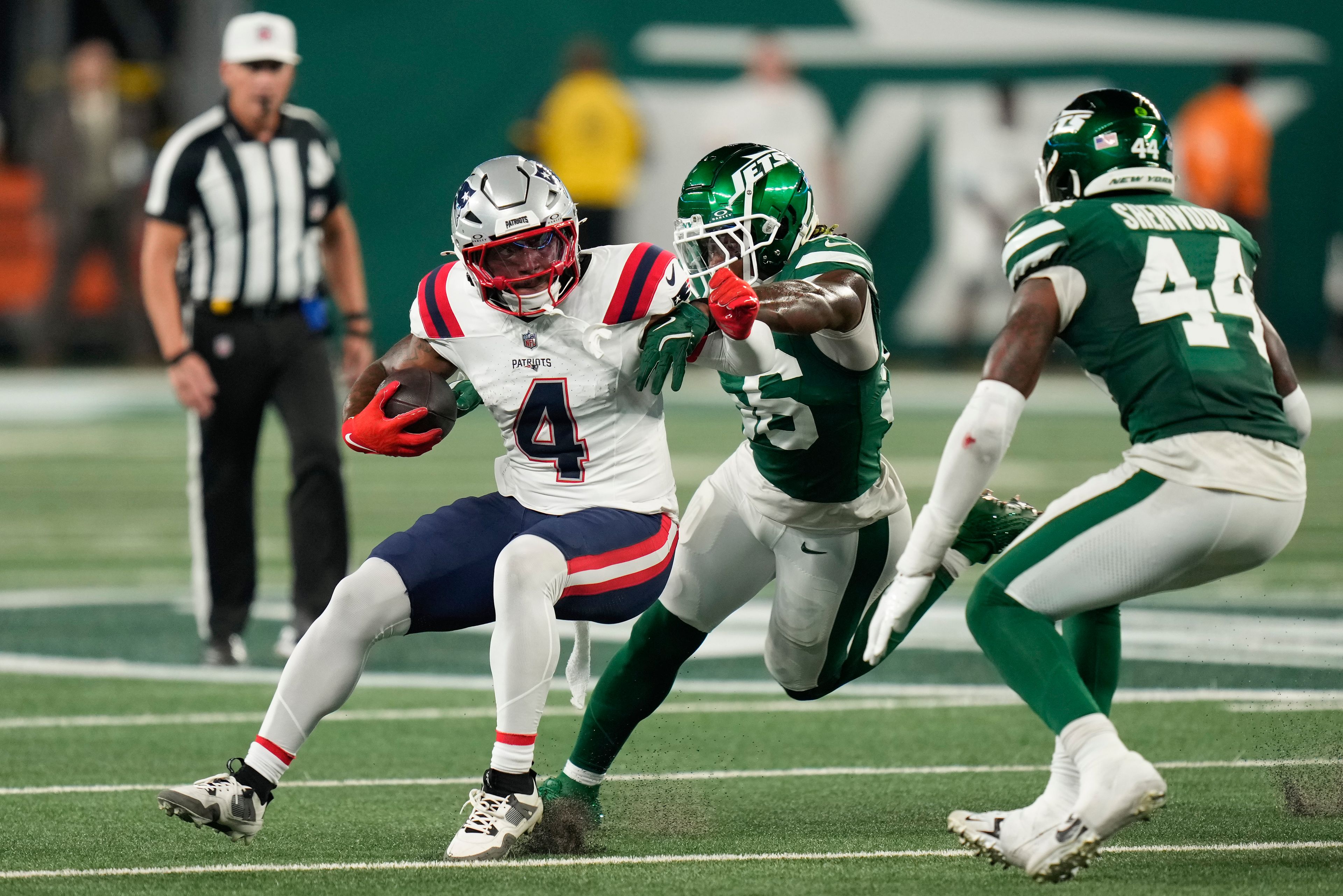 New England Patriots running back Antonio Gibson (4) carries the ball against the New York Jets during the second quarter of an NFL football game, Thursday, Sept. 19, 2024, in East Rutherford, N.J. (AP Photo/Seth Wenig)