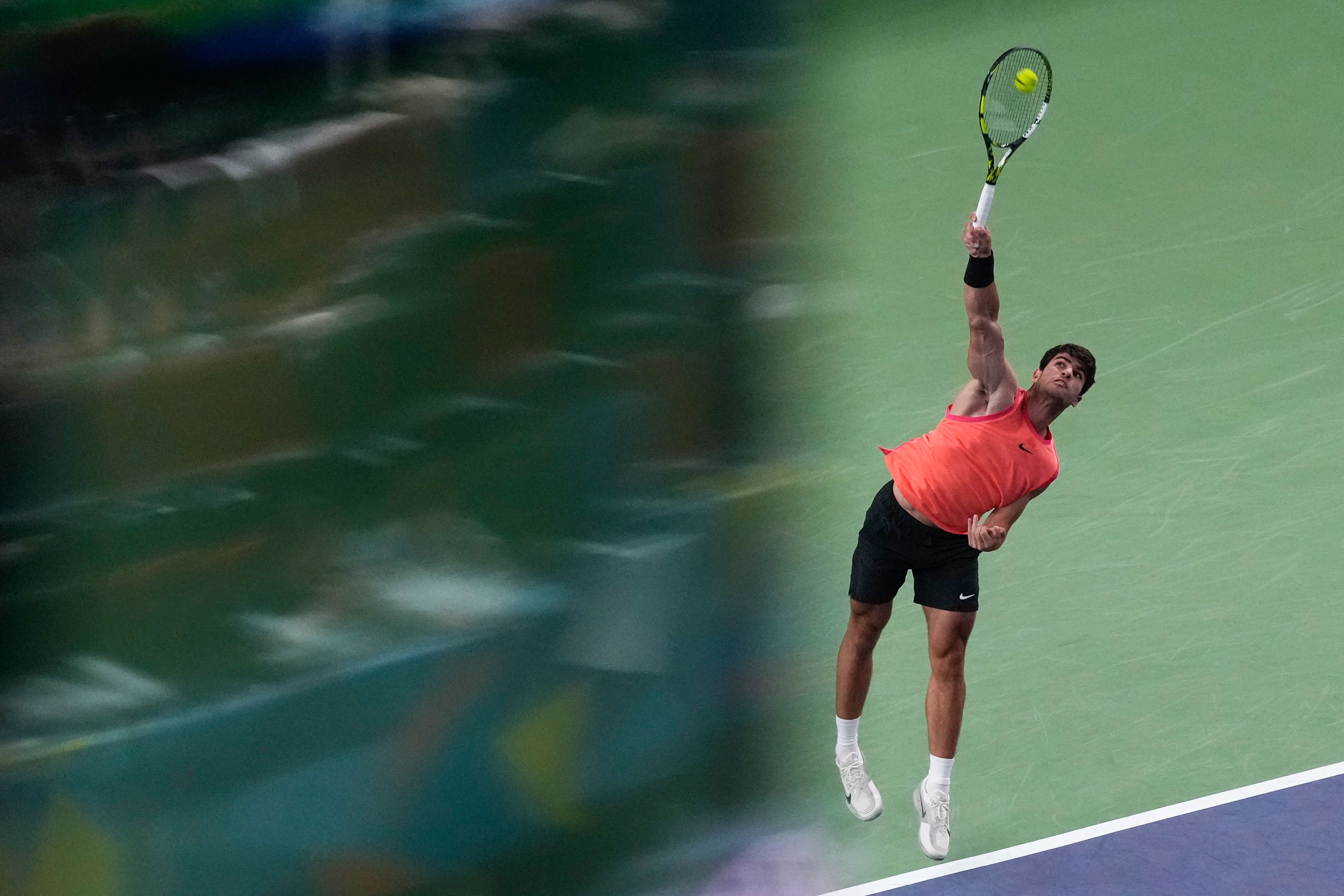 Carlos Alcaraz of Spain serves against Tomas Machac of the Czech Republic during the men's singles quarterfinals match in the Shanghai Masters tennis tournament at Qizhong Forest Sports City Tennis Center in Shanghai, China, Thursday, Oct. 10, 2024. (AP Photo/Andy Wong)