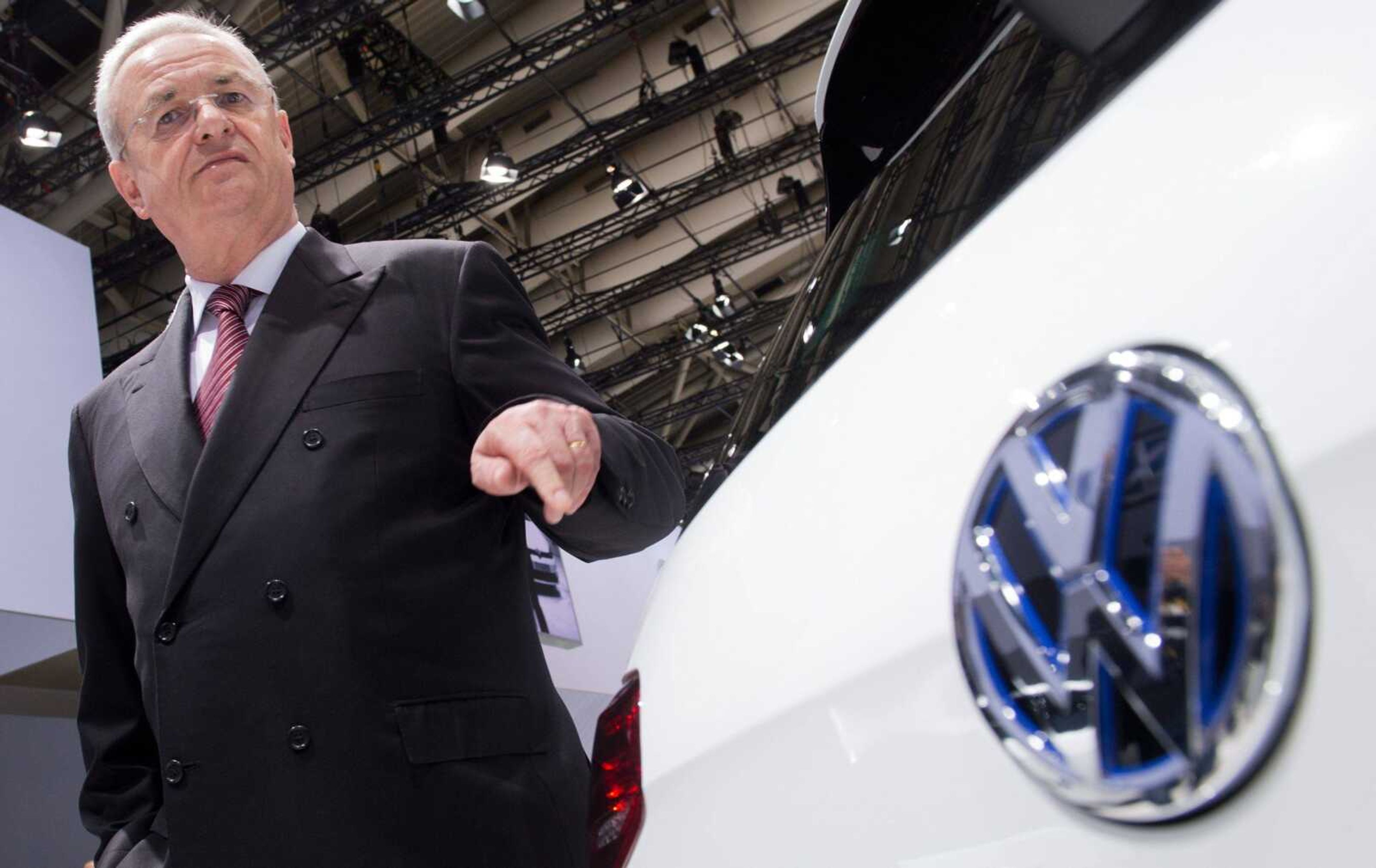 Martin Winterkorn stands next to a VW car at a 2014 shareholder meeting in Hannover, Germany. German prosecutors said Monday they have opened an investigation of former Volkswagen CEO Winterkorn on allegations of market manipulation in connection with the company's scandal over cars rigged to cheat on U.S. diesel emissions tests.