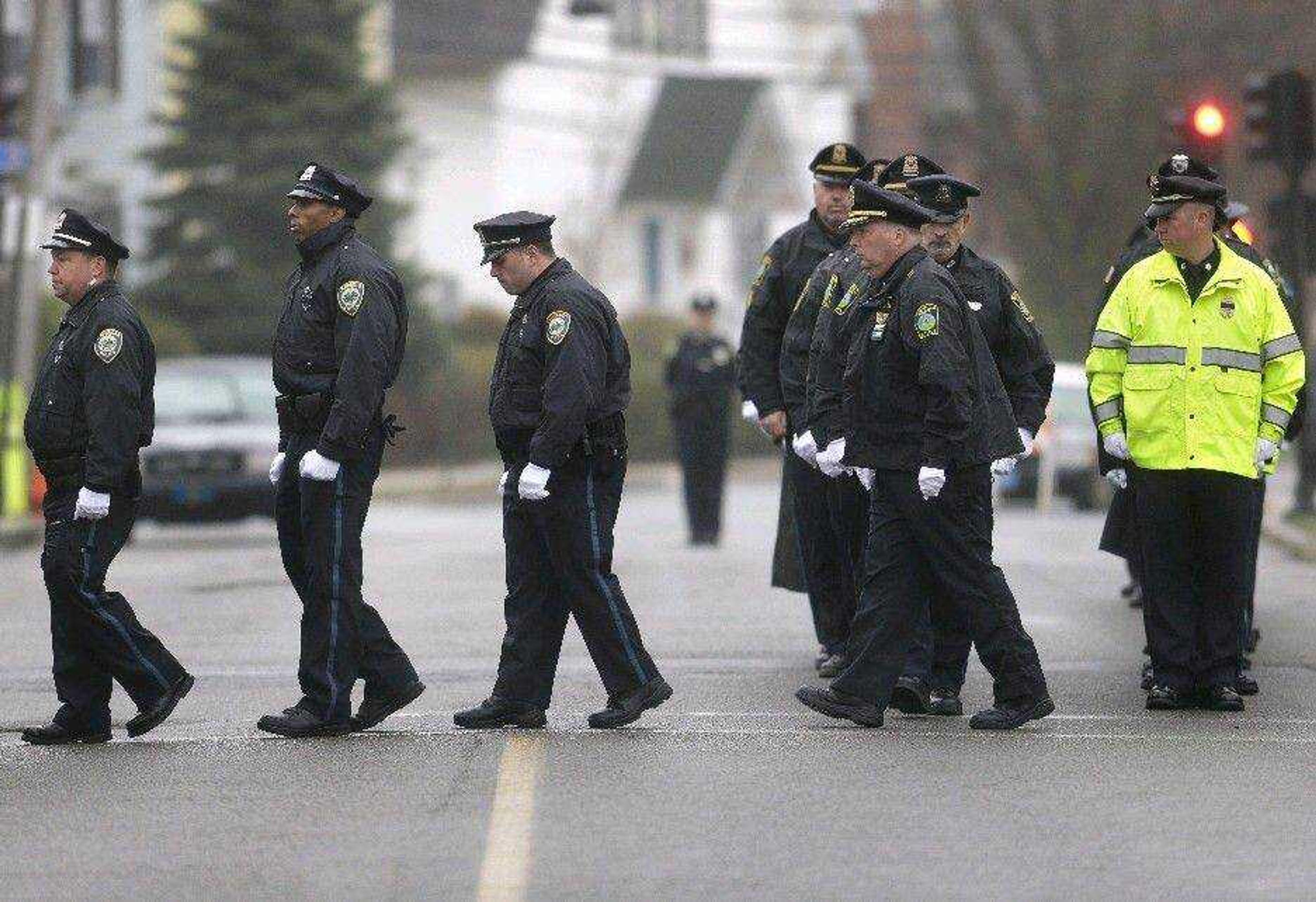 Police officers march in formation as they enter St. Patrick&#8217;s Church on Tuesday in Stoneham, Mass., before a funeral Mass for Massachusetts Institute of Technology police officer Sean Collier. (Steven Senne ~ Associated Press)