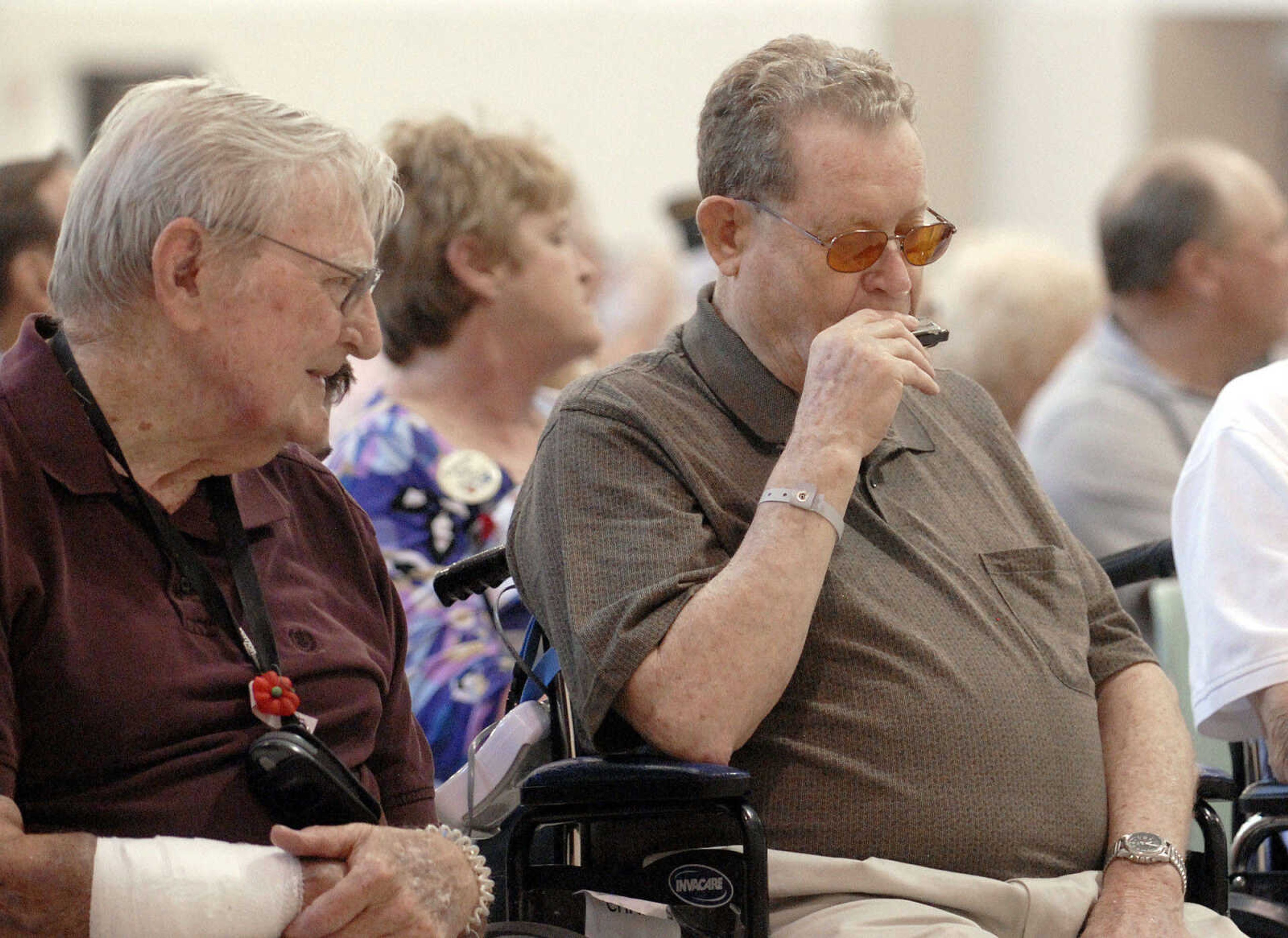 LAURA SIMON~lsimon@semissourian.com
Ed Esicar listens as fellow veteran Charles Werner plays a harmonica along with the Cape Girardeau Municipal Band during the Memorial Day service Monday, May 30, 2011 at the Osage Centre in Cape Girardeau.