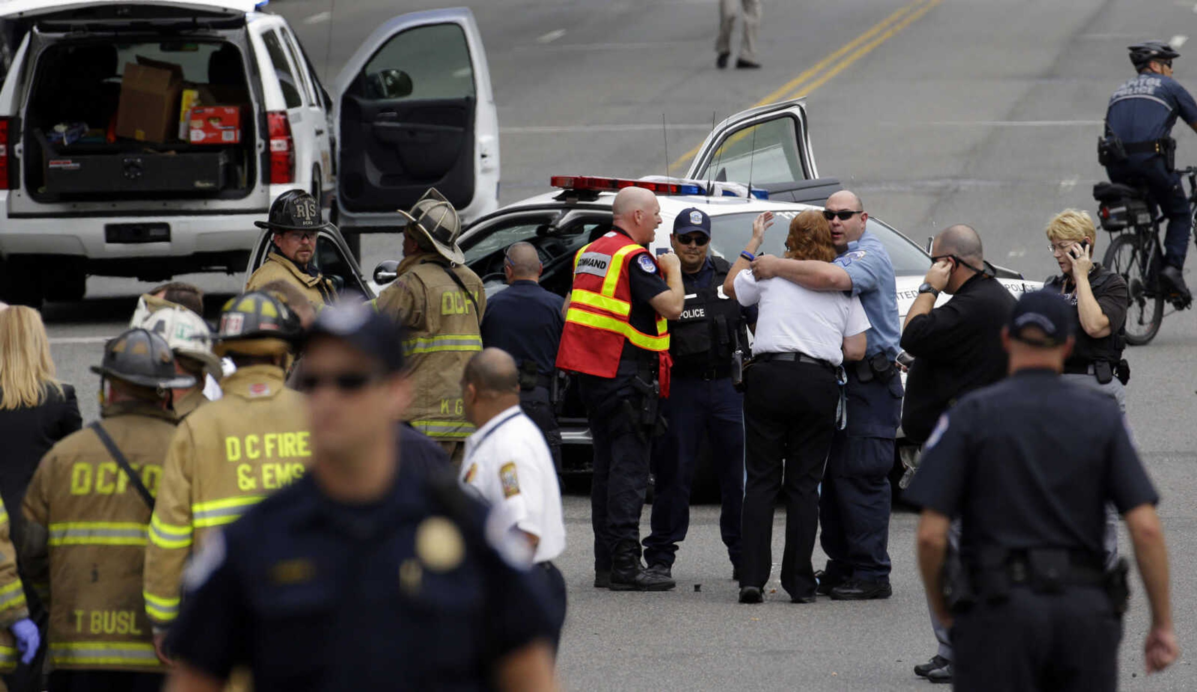 Police gather near the scene on Capitol Hill in Washington, Thursday, Oct. 3, 2013, after gunshots were heard. Police say the U.S. Capitol has been put on a security lockdown amid reports of possible shots fired outside the building.  (AP Photo/Alex Brandon)