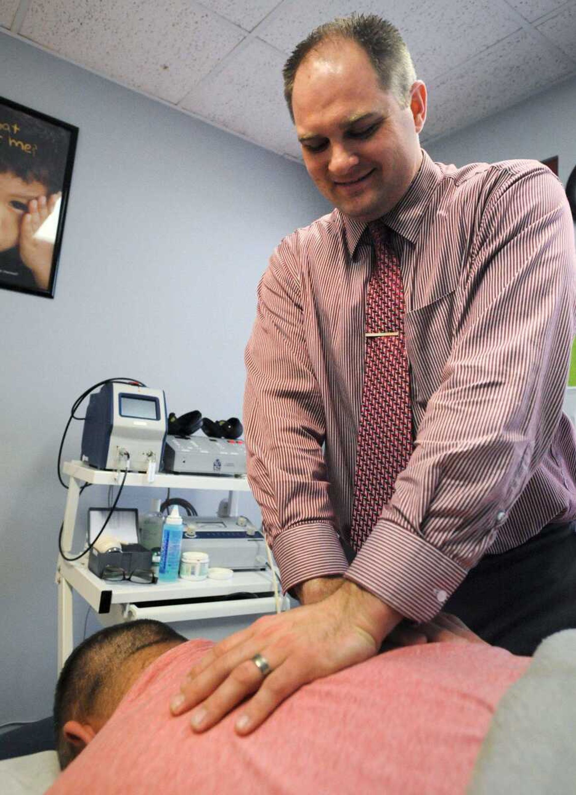 TBY cutline:Dr. Gregory W. Pursley works on a patient inside PC Wellness Centers in Cape Girardeau. (Laura Simon)