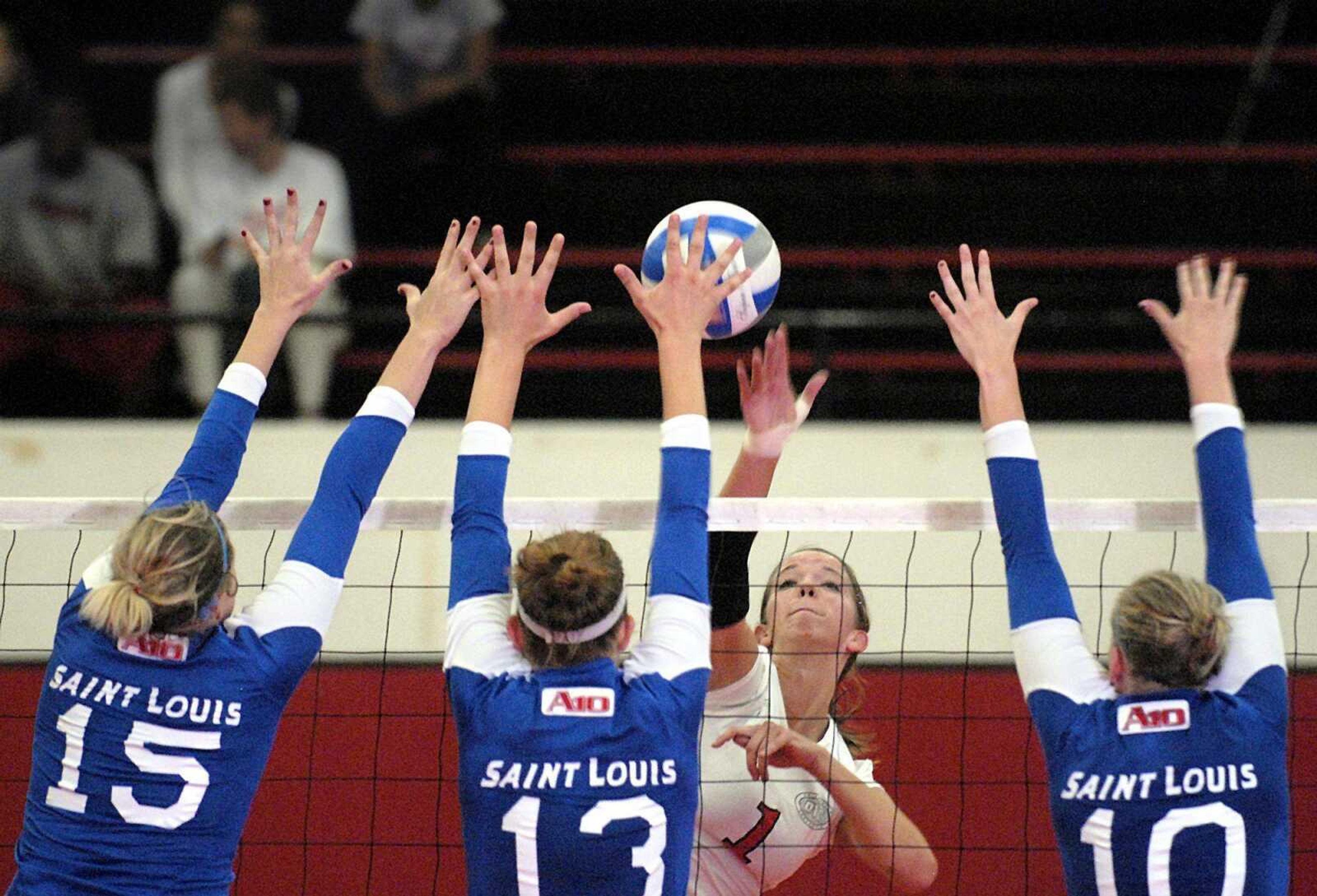 Southeast's Emily Hughes, center, attempts a kill against Saint Louis blockers Casey Chernin, from left, Sally Warning and Sammi McCloud during game two Wednesday.