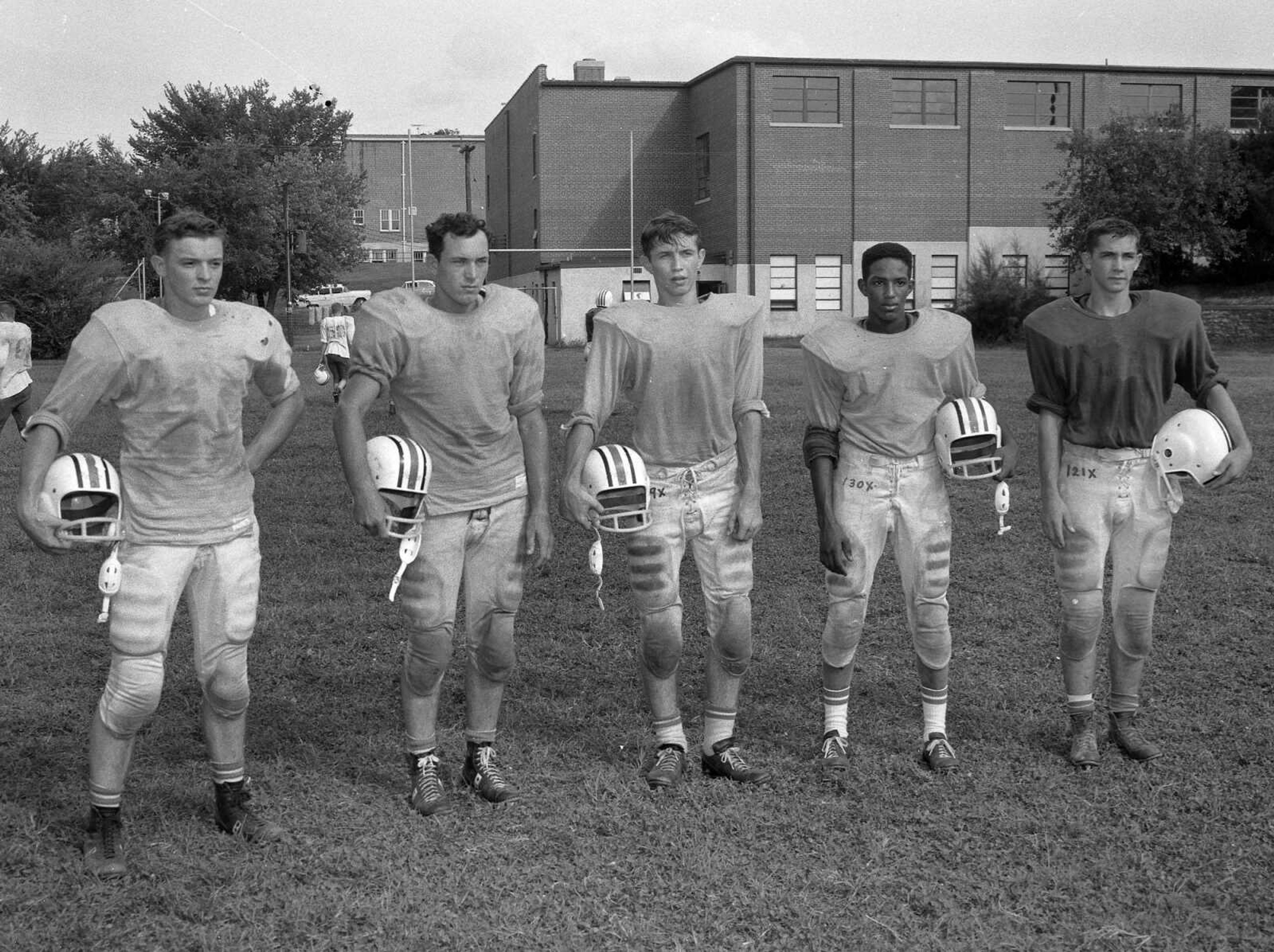 Five Jackson football players were pulled away from practice to have their photo made for the newspaper. Mike Masterson wrote: "The five football players are, from left to right: Tony Kirn, Adolph Sokolowski, Fred Jones, Larry Lewis, Ray Schweain."