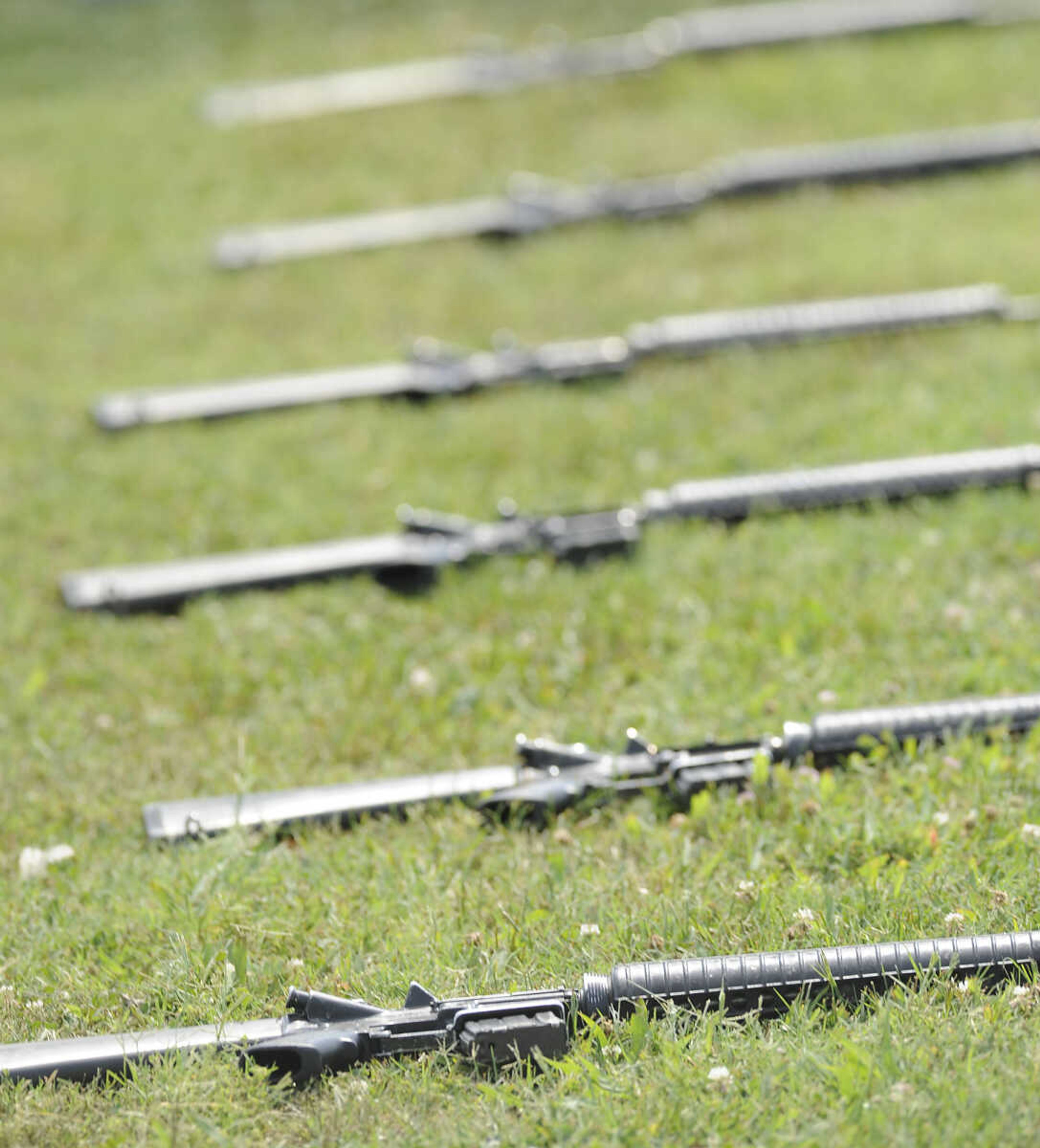 The honor guard's rifles lie on the grass during the funeral for U.S. Army Air Forces 1st Lt. Warren G. Moxley Tuesday, July 3, at the Odd Fellows Cemetery in Charleston, Mo. A pilot with the 67th Tactical Recon Group's 107th Observation Squadron Moxley was killed on March 15, 1945, when his F6, a photo-reconnaissance model of the P-51 Mustang, was shot down over Germany by anti-aircraft fire. His remains were identified using DNA earlier this year.