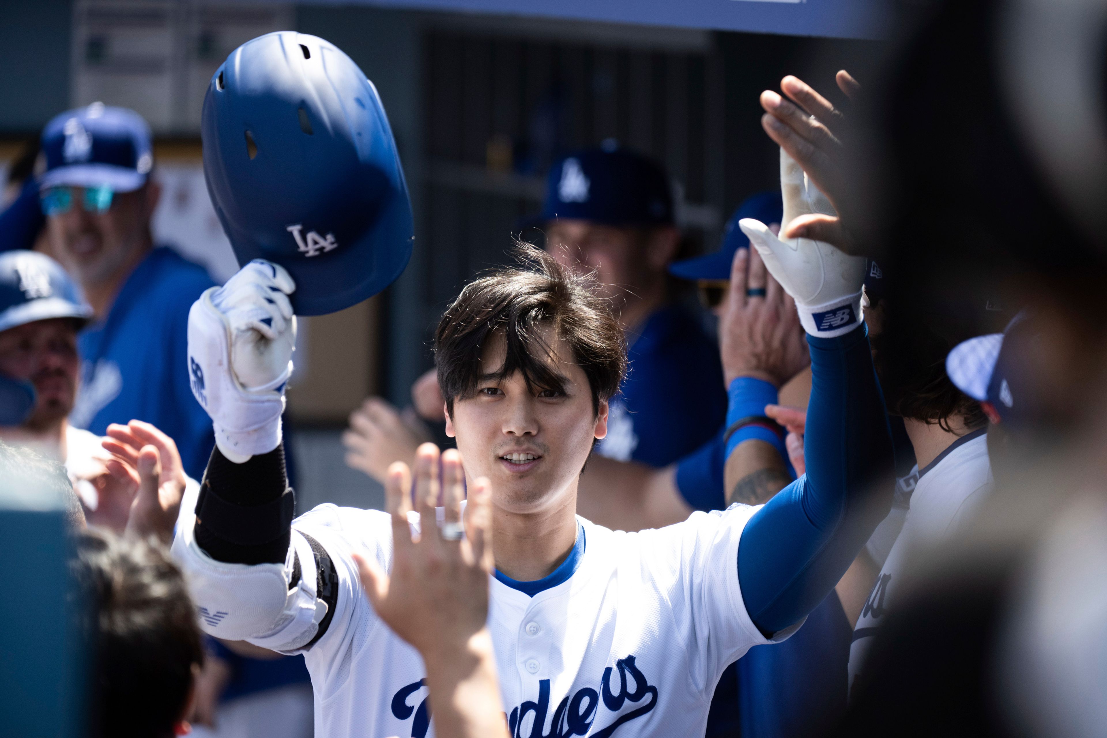 Los Angeles Dodgers' Shohei Ohtani celebrates after his two-run home run in the dugout during the third inning of a baseball game against the New York Mets in Los Angeles, Sunday, April 21, 2024. (AP Photo/Kyusung Gong)