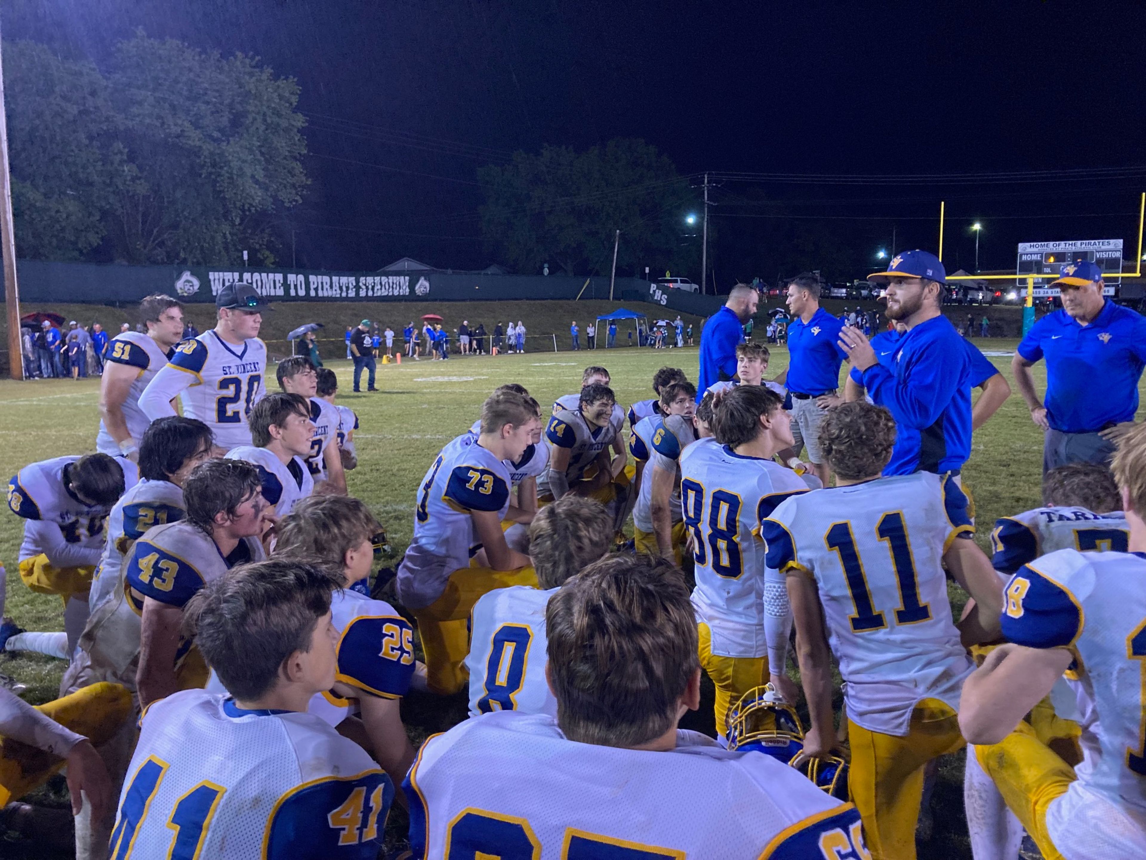 St. Vincent coach Tim Schumer, second from right, addresses his team following Friday's road win over Perryville.