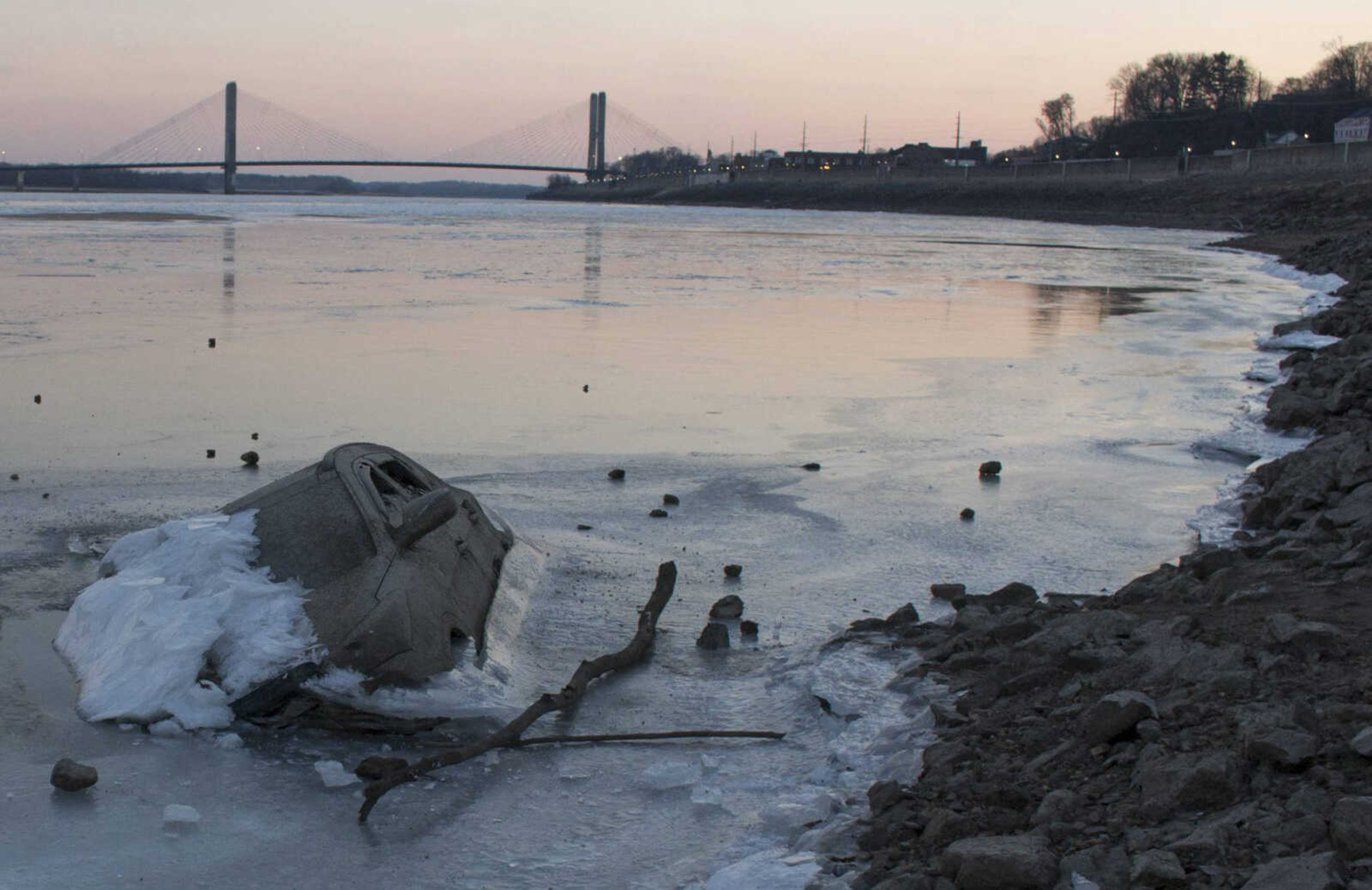 A sunken vehicle protrudes through a frozen section of the Mississippi River on Wednesday in Cape Girardeau.