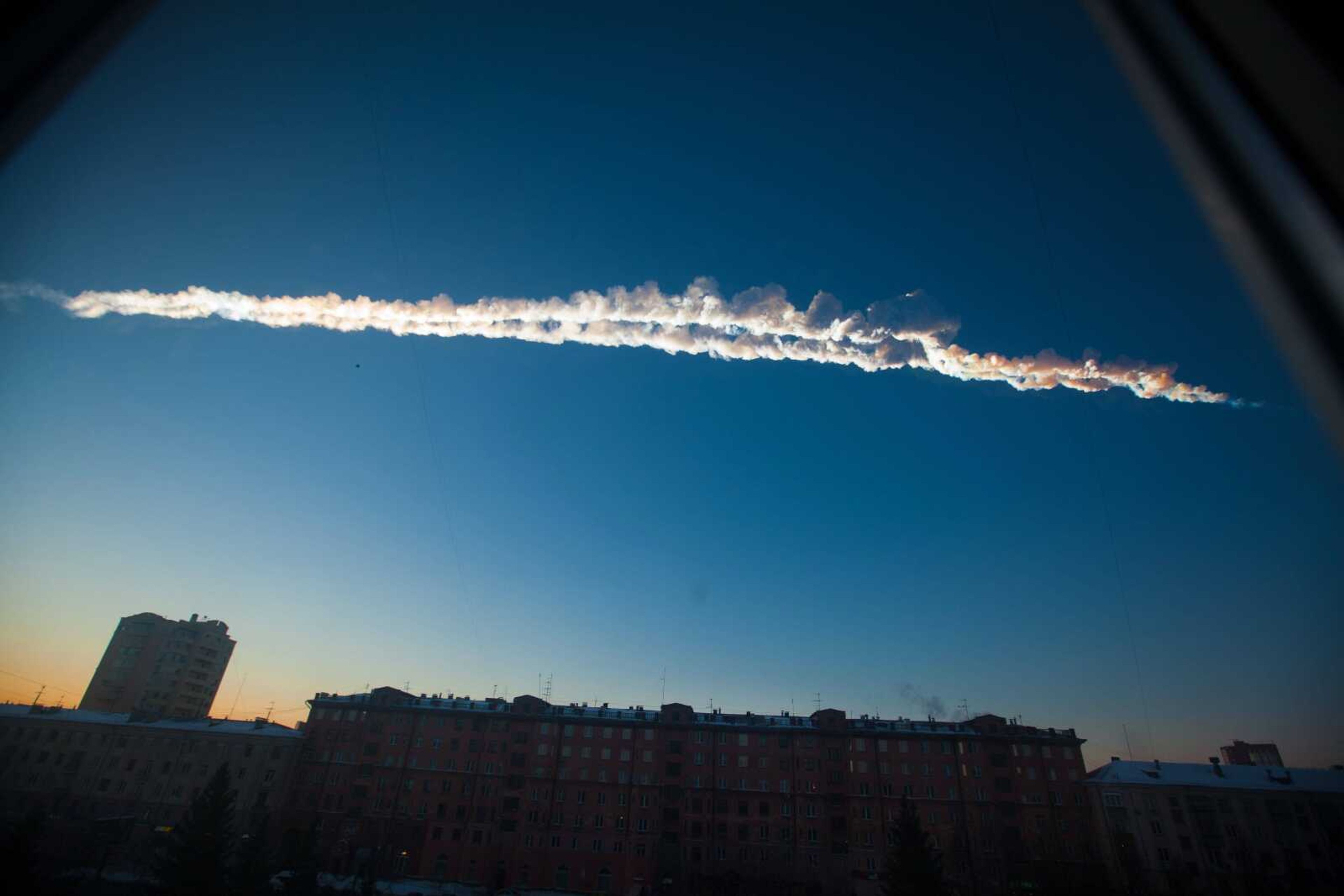 A meteorite contrail is seen over Chelyabinsk, Russia, in February. Scientists studying the meteor&#8217;s aftermath say the threat of space rocks hurtling toward our planet is bigger than they had thought. (Yekaterina Pustynnikova ~ Chelyabinsk.ru)