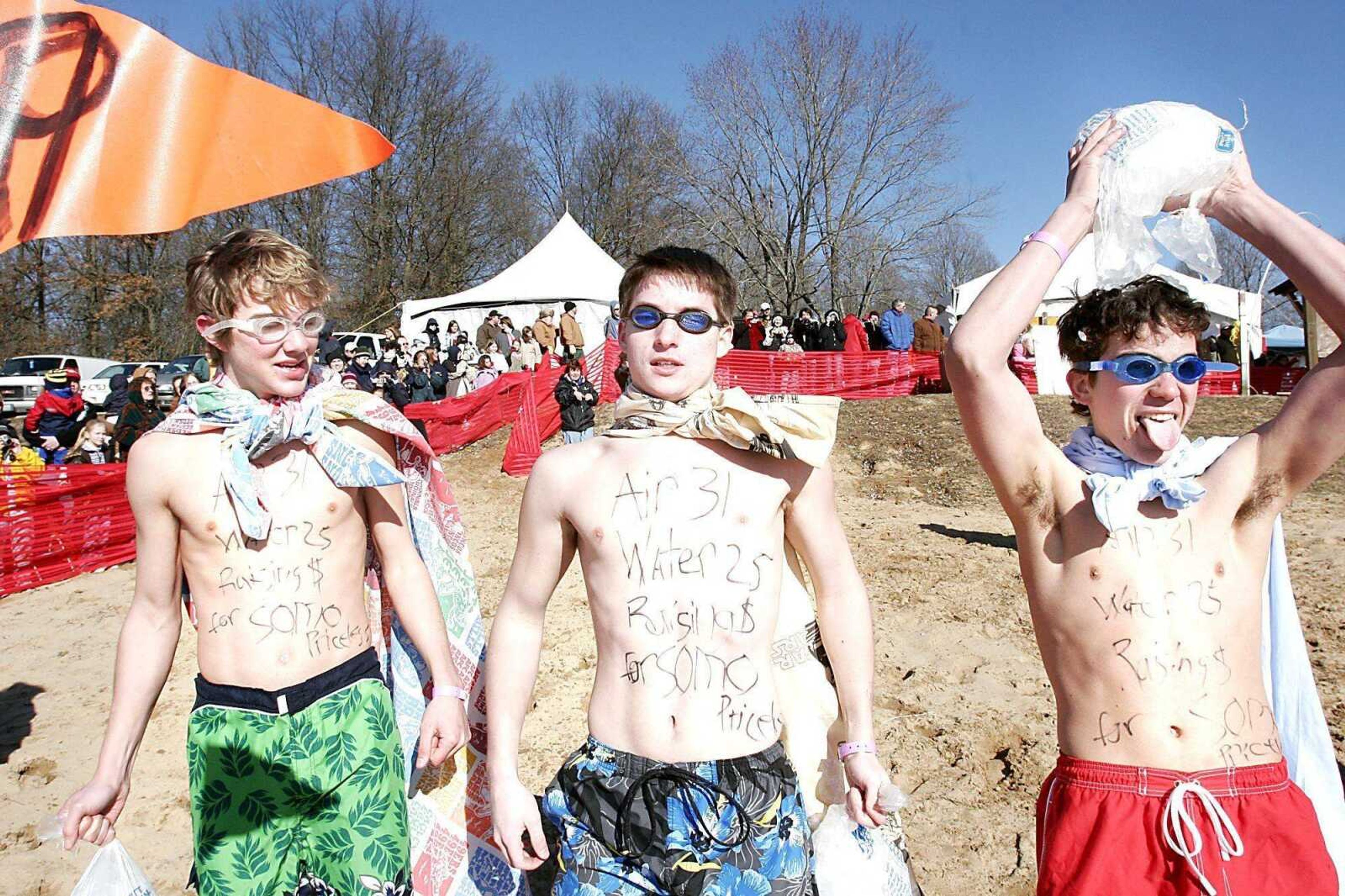 Saxony Lutheran High students, from left, Brandon Etzold, Ben Meyr and Ben Skelton carried ice with them into Trail of Tears State Park's Lake Boutin on Feb. 3 at the Southeast Area Polar Bear Plunge.  The Special Olympics fundraiser had more than 80 costumed participants jump into the 37-degree water.  The boys won second place in the "Golden Plunger" costume competition. (Kit Doyle)