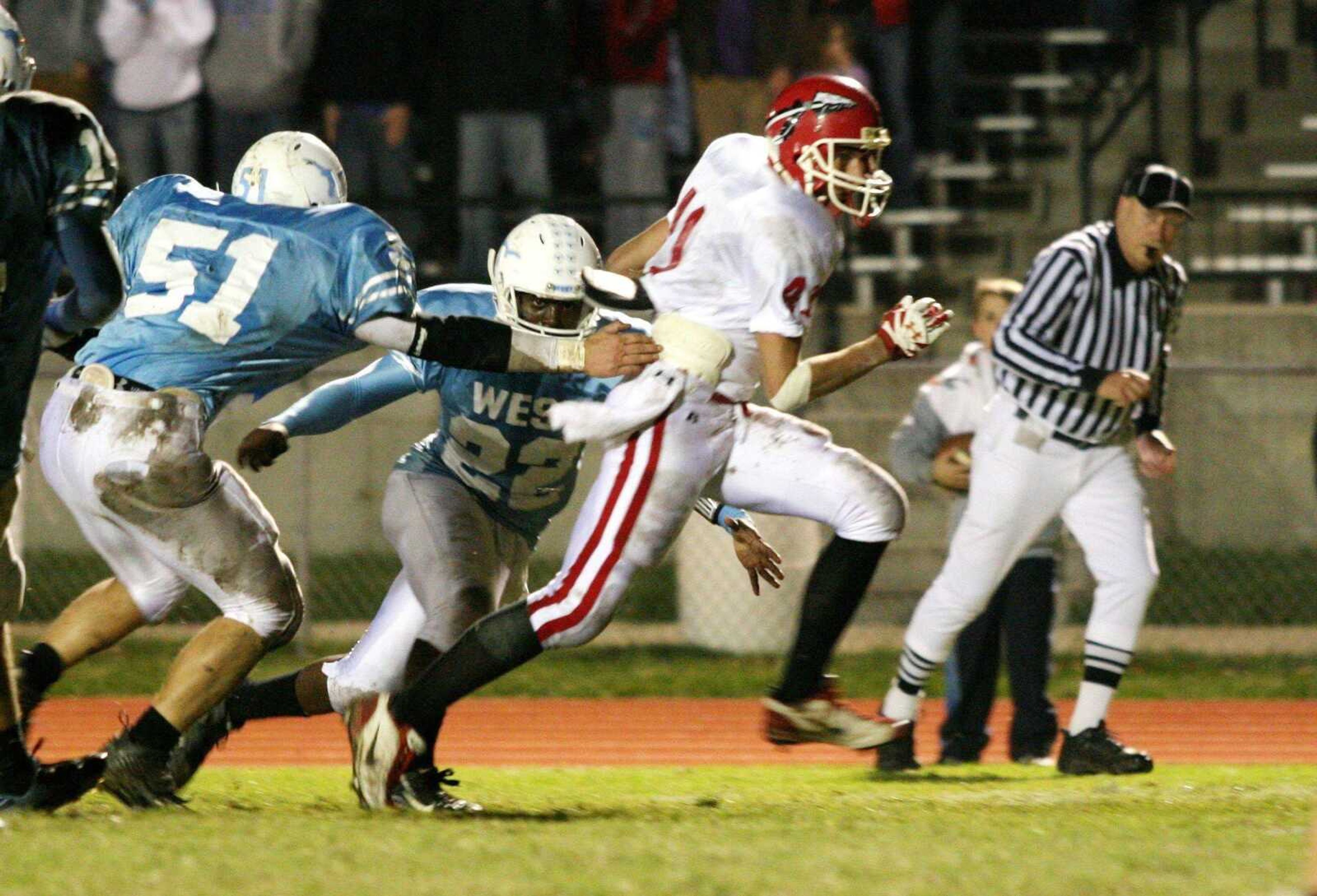 Jackson's Adam Zweigart broke away from Parkway West's Brian Gerike (51) and Torrence Watkins (22) on a first-quarter touchdown run  Friday night  in Ballwin, Mo.