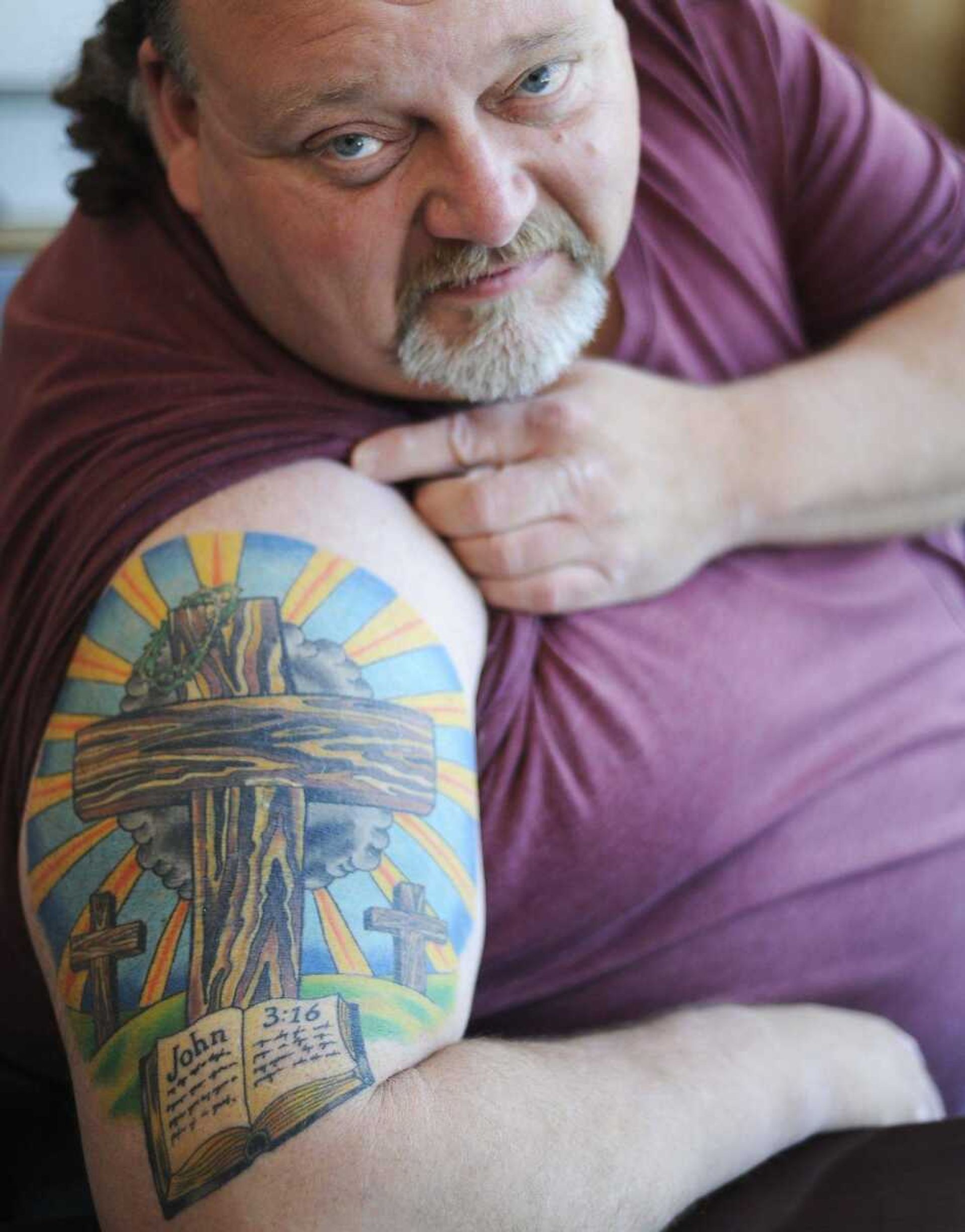 Jeff Starr shows a tattoo he got to cover up another tattoo of a Tasmanian devil Wednesday, Aug. 14, in the office of his Anna, Ill., car dealership. Starr played Mike Engelbert in "The Bad News Bears In Breaking Training" and "The Bad News Bears Go To Japan" in the late 1970s. (Adam Vogler)