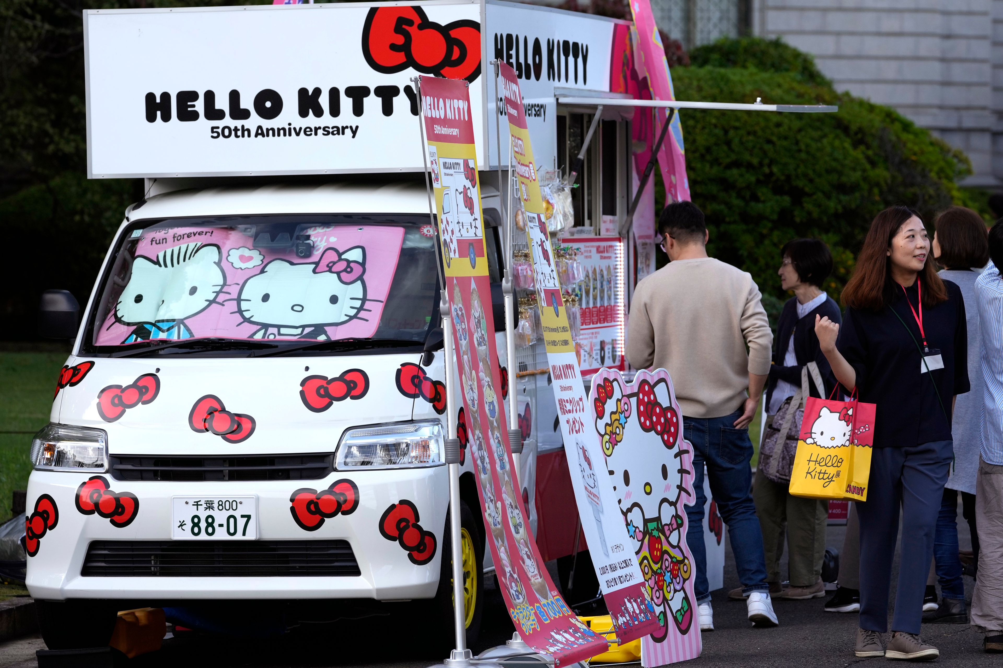 A food vendor's van is decorated with Hello Kitty images outside the National Museum during the exhibition "As I change, so does she," marking the 50th anniversary of Hello Kitty at the National Museum in Tokyo Wednesday, Oct. 30, 2024. (AP Photo/Shuji Kajiyama)