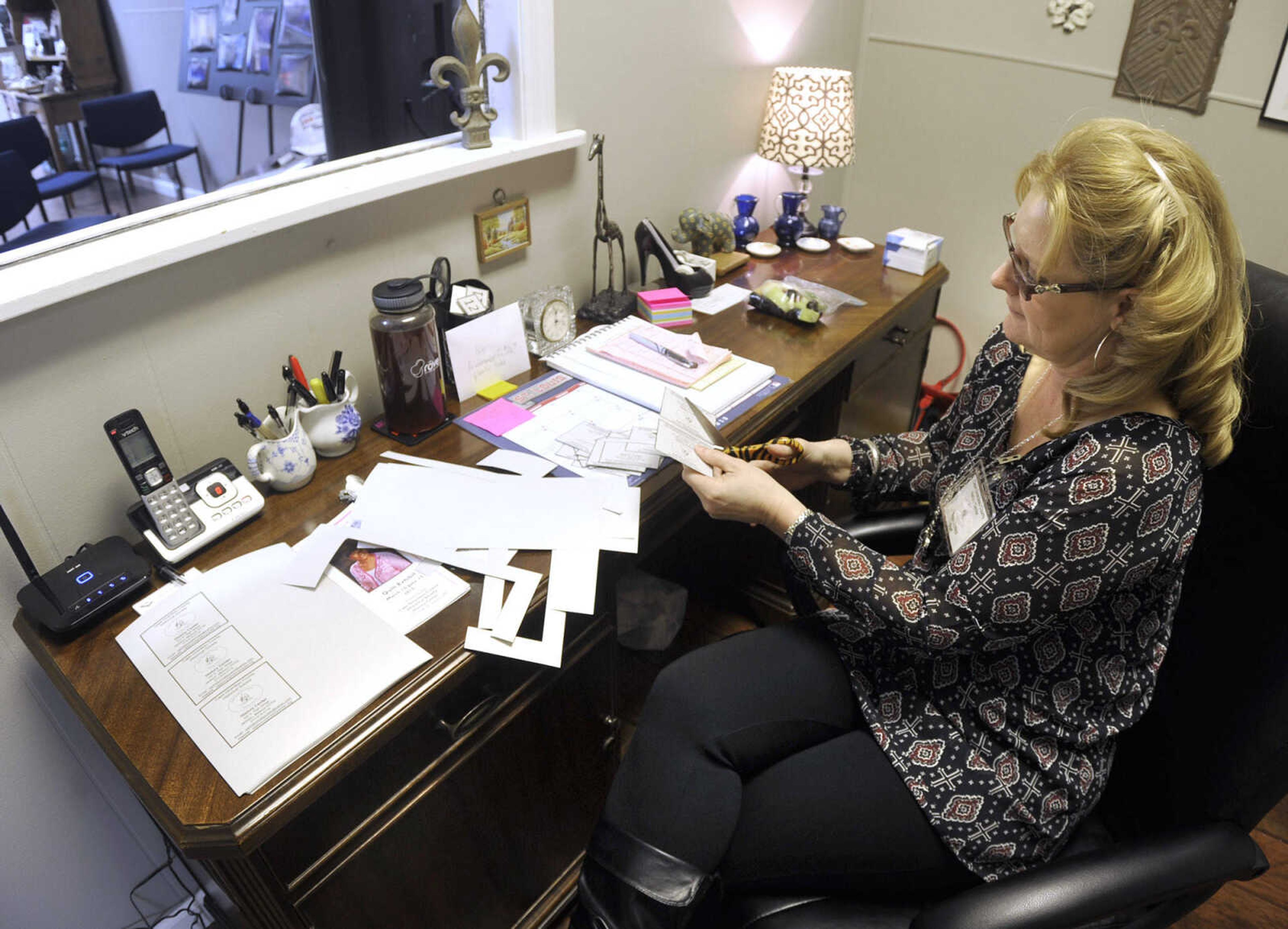 Trish Erzfeld, a staff member of the Cape Girardeau County History Center, sits at a desk that was used by U.S. Rep. Jo Ann Emerson at the federal building in Cape Girardeau, on Sunday, March 15, 2015 at the center in Jackson.