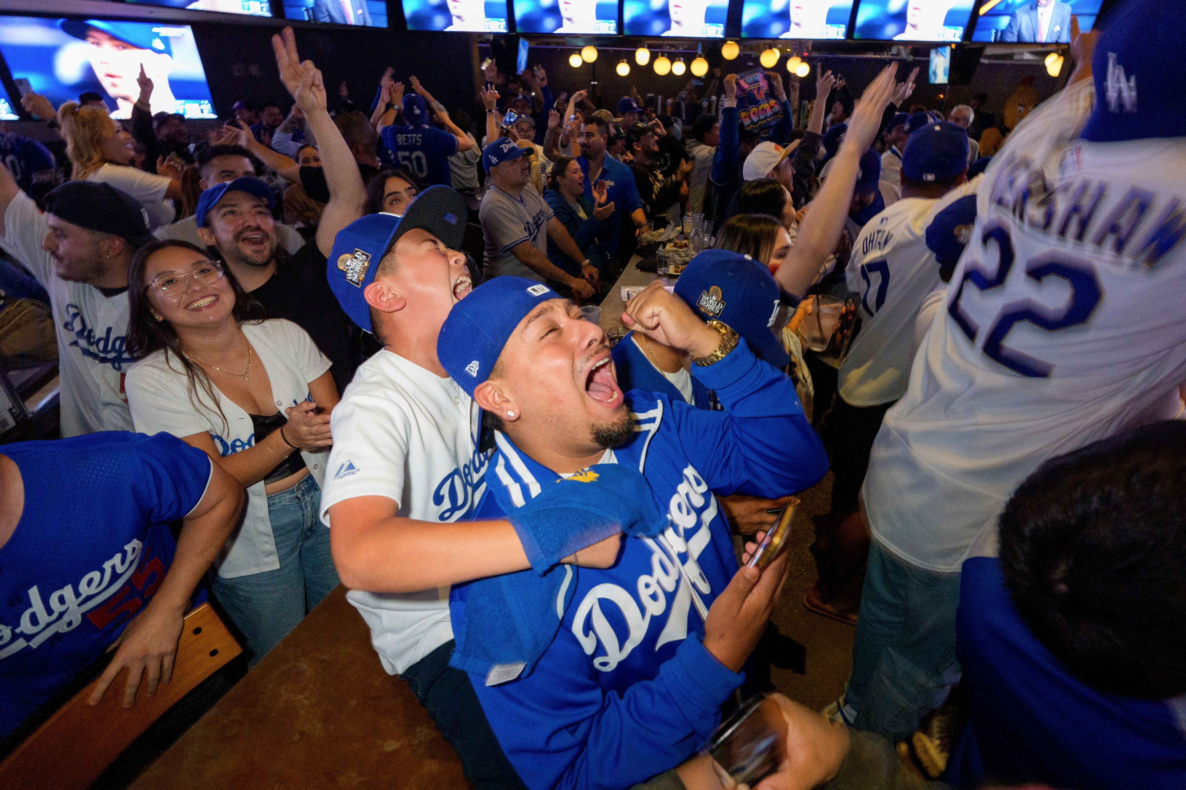 Fans celebrate after the Los Angeles Dodgers defeated the New York Yankees to win the baseball World Series Wednesday, Oct. 30, 2024, in Los Angeles. (AP Photo/Damian Dovarganes)