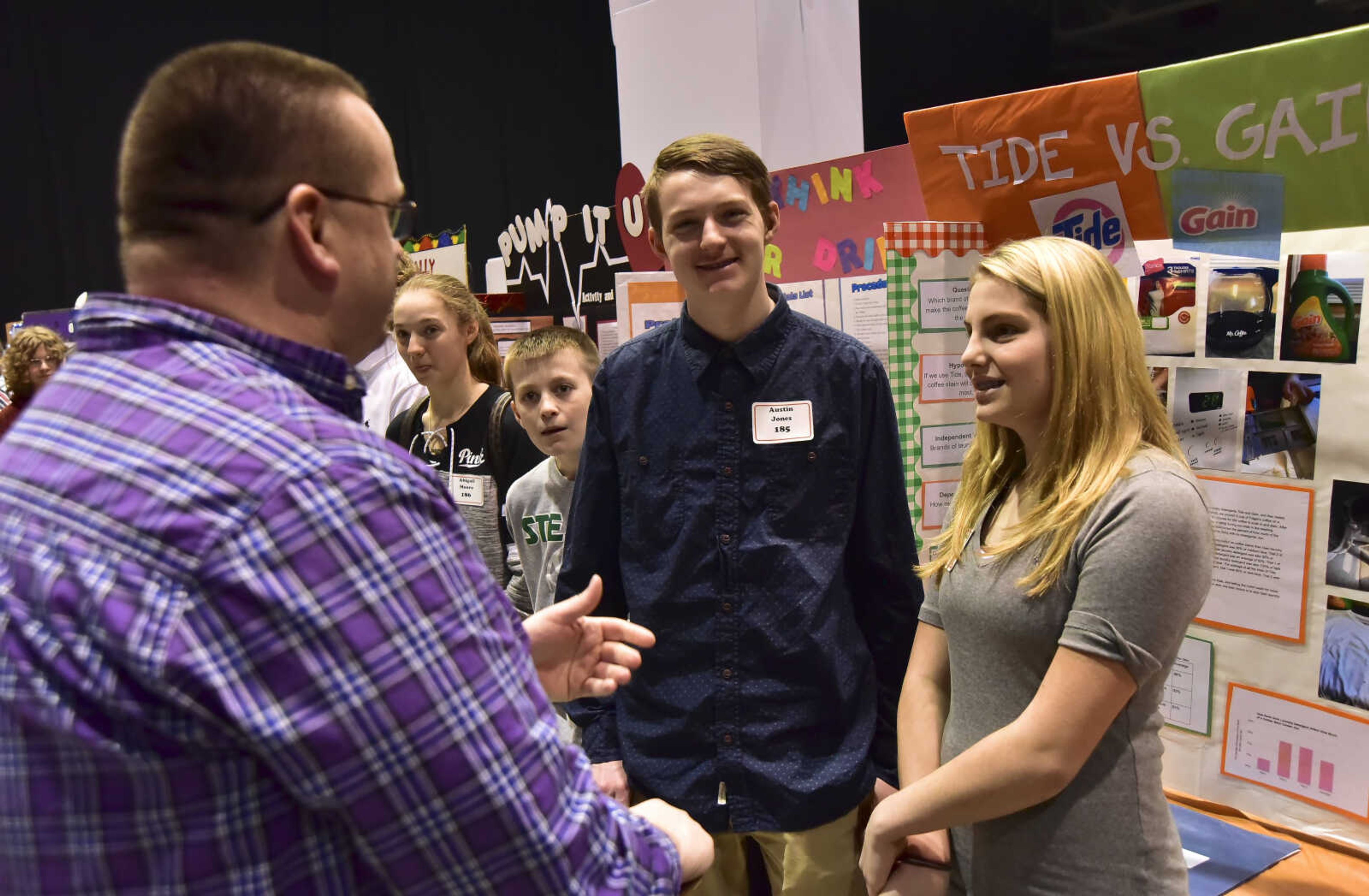 Judge Jim McGill talks to Austin Jones and his sister Avadeania Jones about their project on comparing which brand of detergent gets a coffee stain out better, their conclusion was Tide had the best results, during the Southeast Missouri Regional Science Fair Tuesday, March 7, 2017 at the Show Me Center in Cape Girardeau.