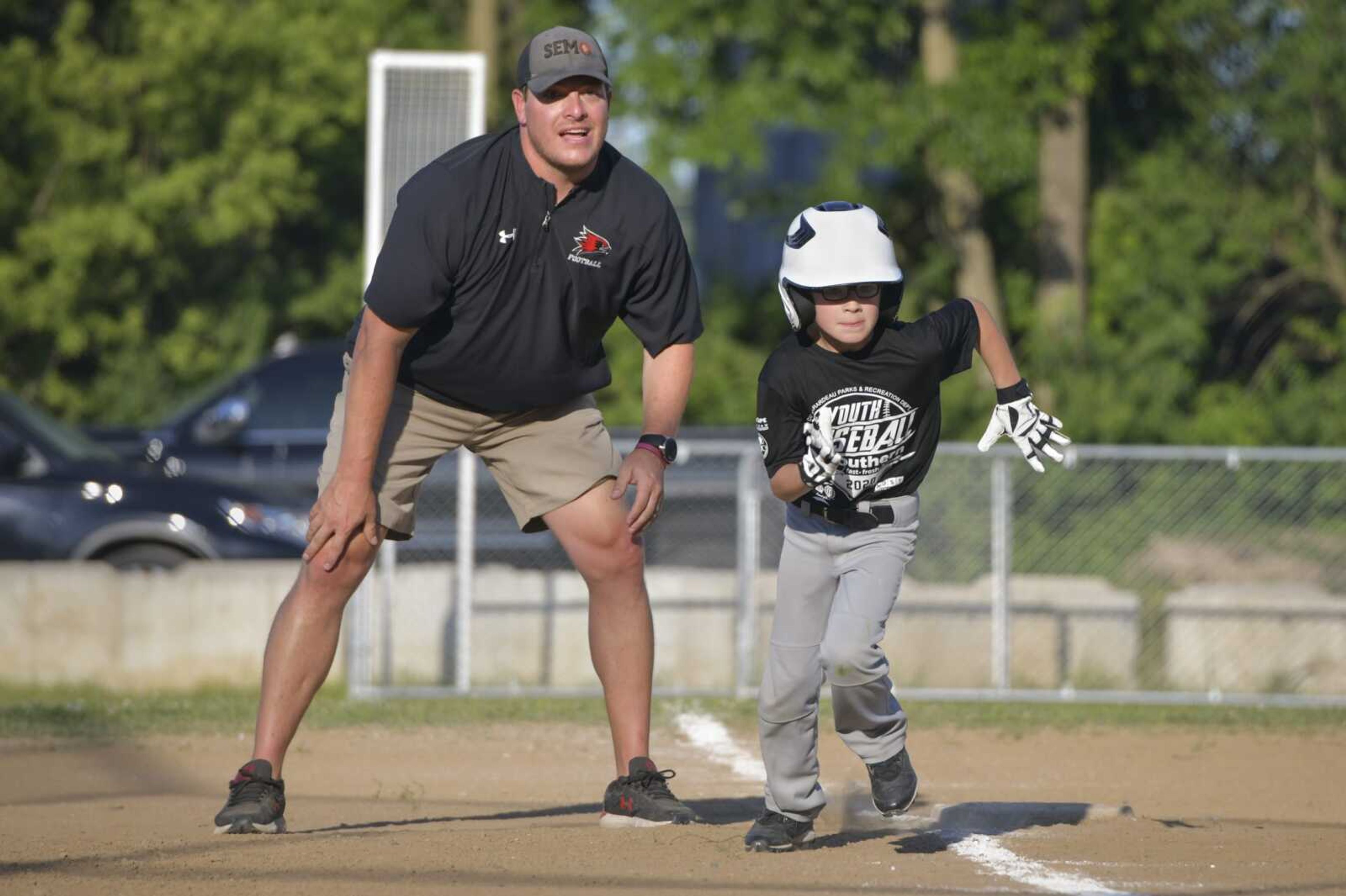 Southeast Missouri State football offensive coordinator and Cape Youth Baseball League third-base coach Jeromy McDowell sends his son Cru to home plate Tuesday, June 16, 2020, at Arena Park Field 8 in Cape Girardeau.