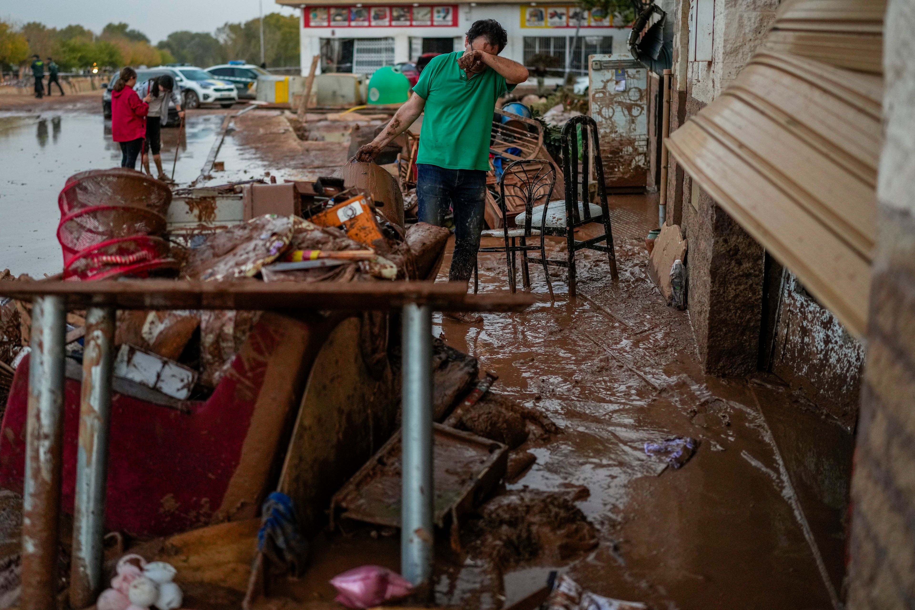 FILE - A man cleans his house affected by floods in Utiel, Spain, Oct. 30, 2024. (AP Photo/Manu Fernandez, File)