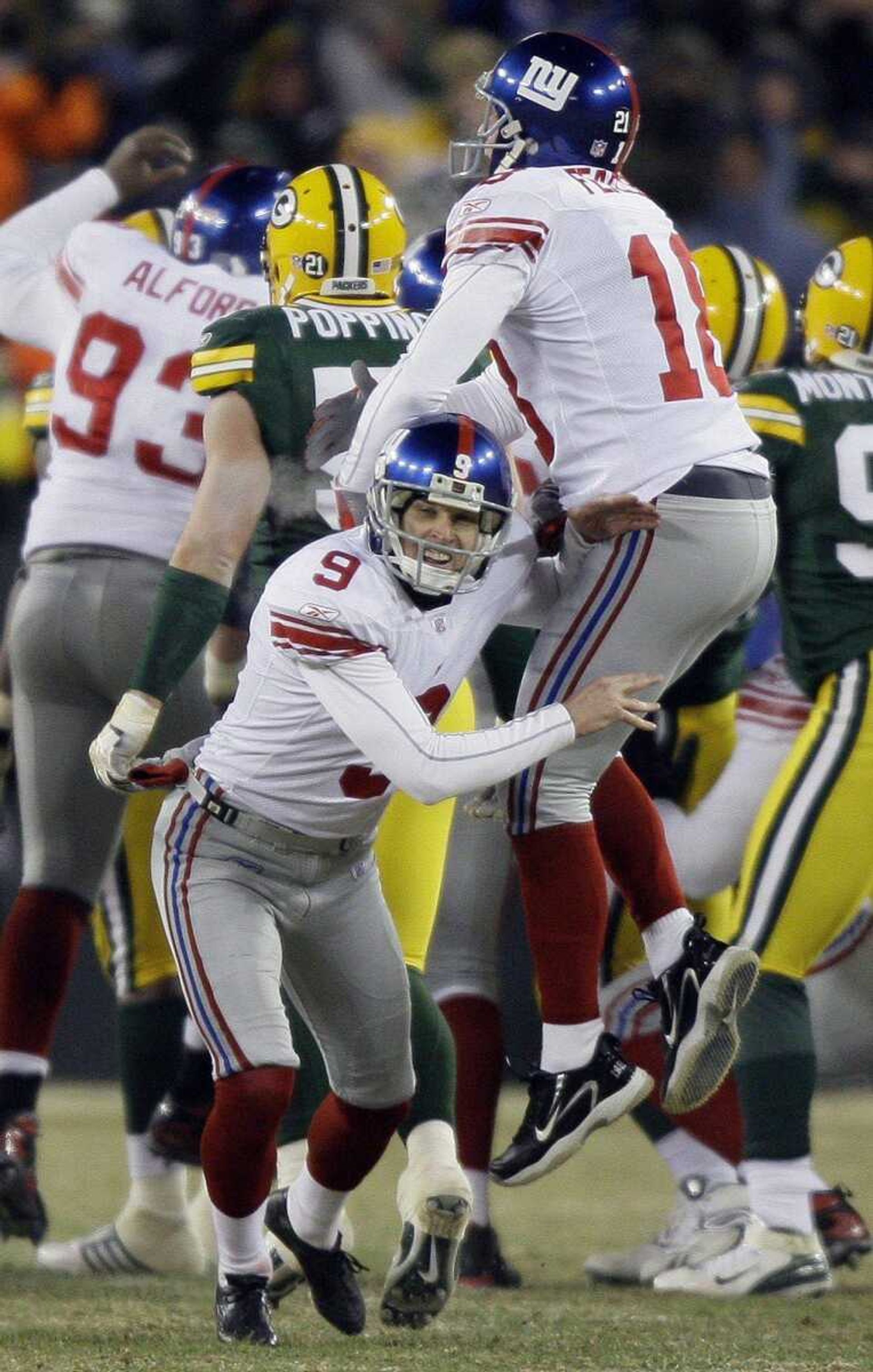 The New York Giants' Lawrence Tynes (9) celebrated with holder Jeff Feagles after kicking the winning field goal in a 23-20 victory over Green Bay in the NFC Championship game. (DAVID J. PHILLIP ~ Associated Press)