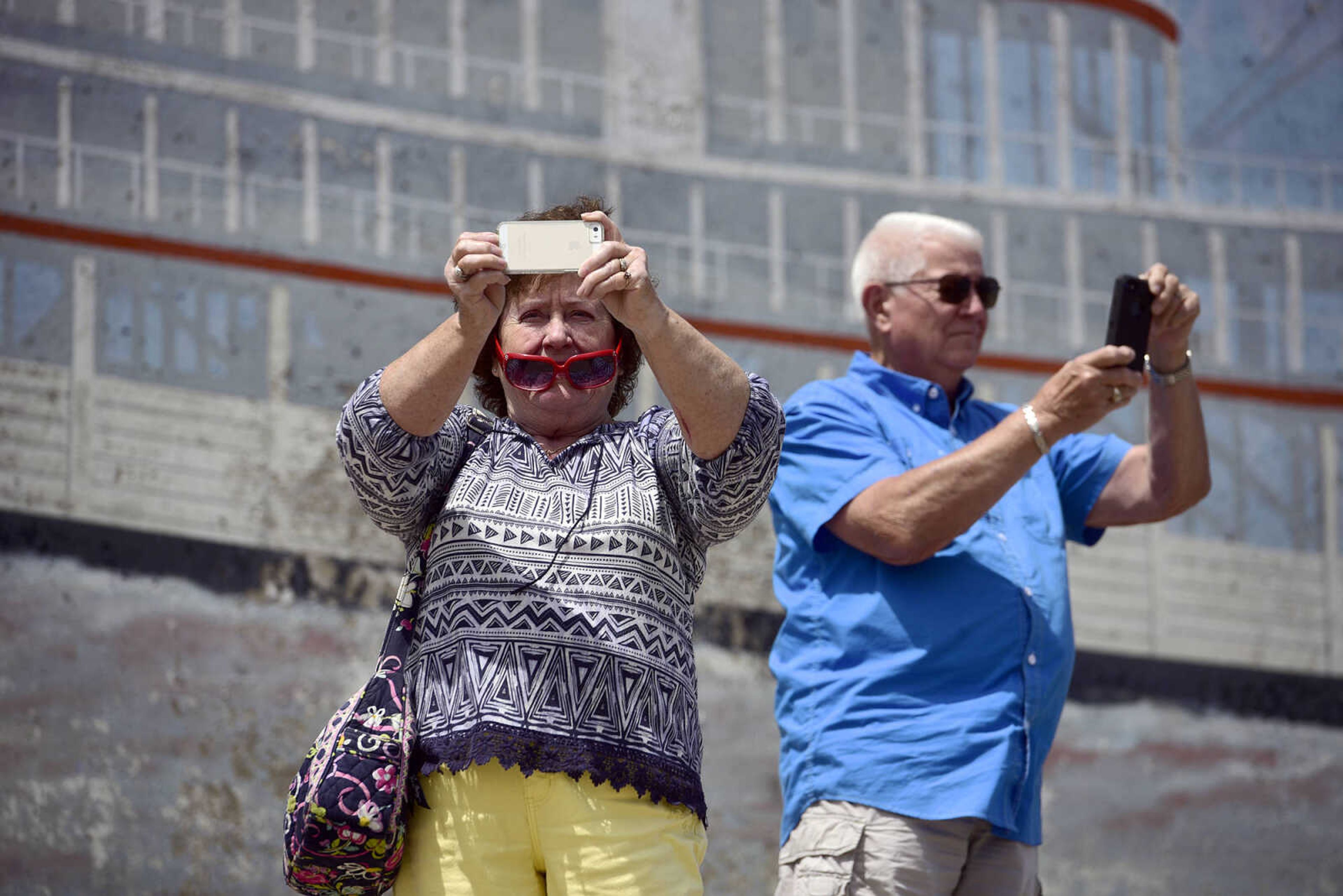 People take photos of the American Queen and the Queen of the Mississippi docked next to each other at Riverfront Park on Wednesday, Aug. 23, 2017, in downtown Cape Girardeau.