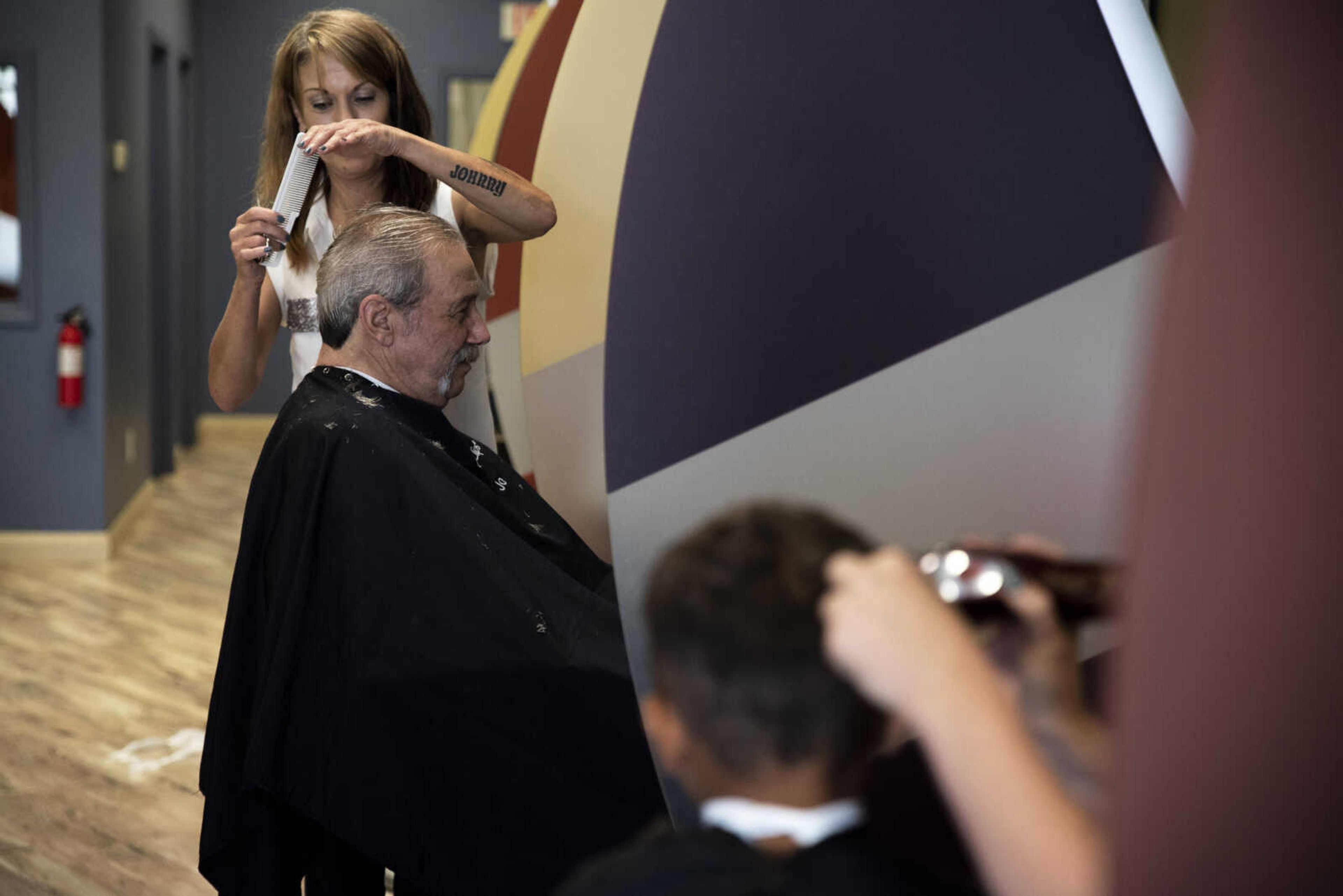 Carl Holmes gets his hair cut by Jo Altom in the station next to his great-grandson Jayce Holmes, 5, at Great Clips Tuesday, June 11, 2019, in Jackson.