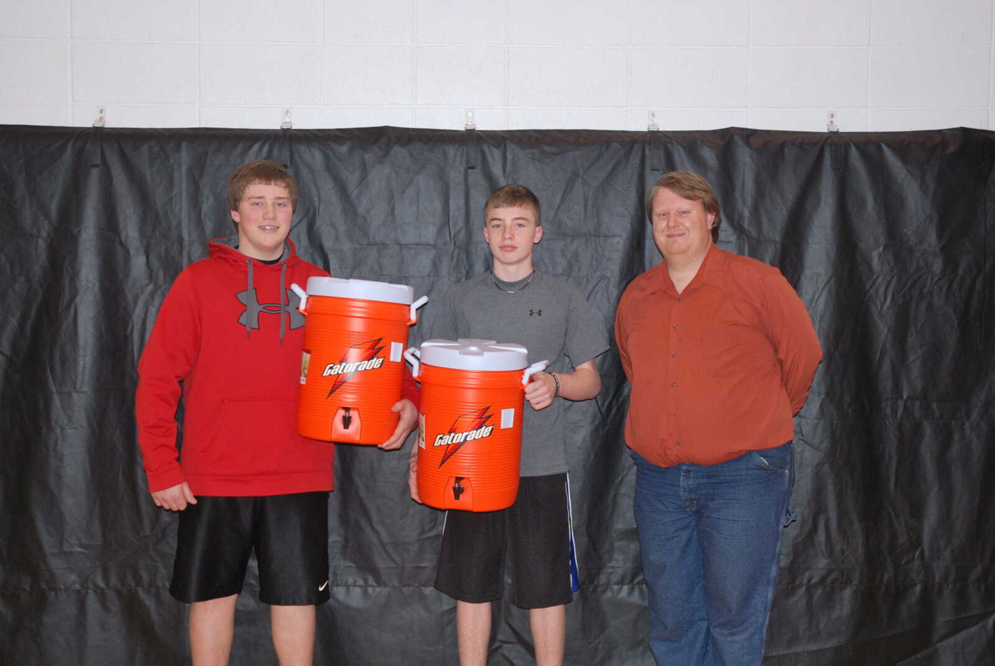 Pictured here is Trevor Morehead and Peyton Montgomery holding the water jugs that were presented to them by William Hargrove.