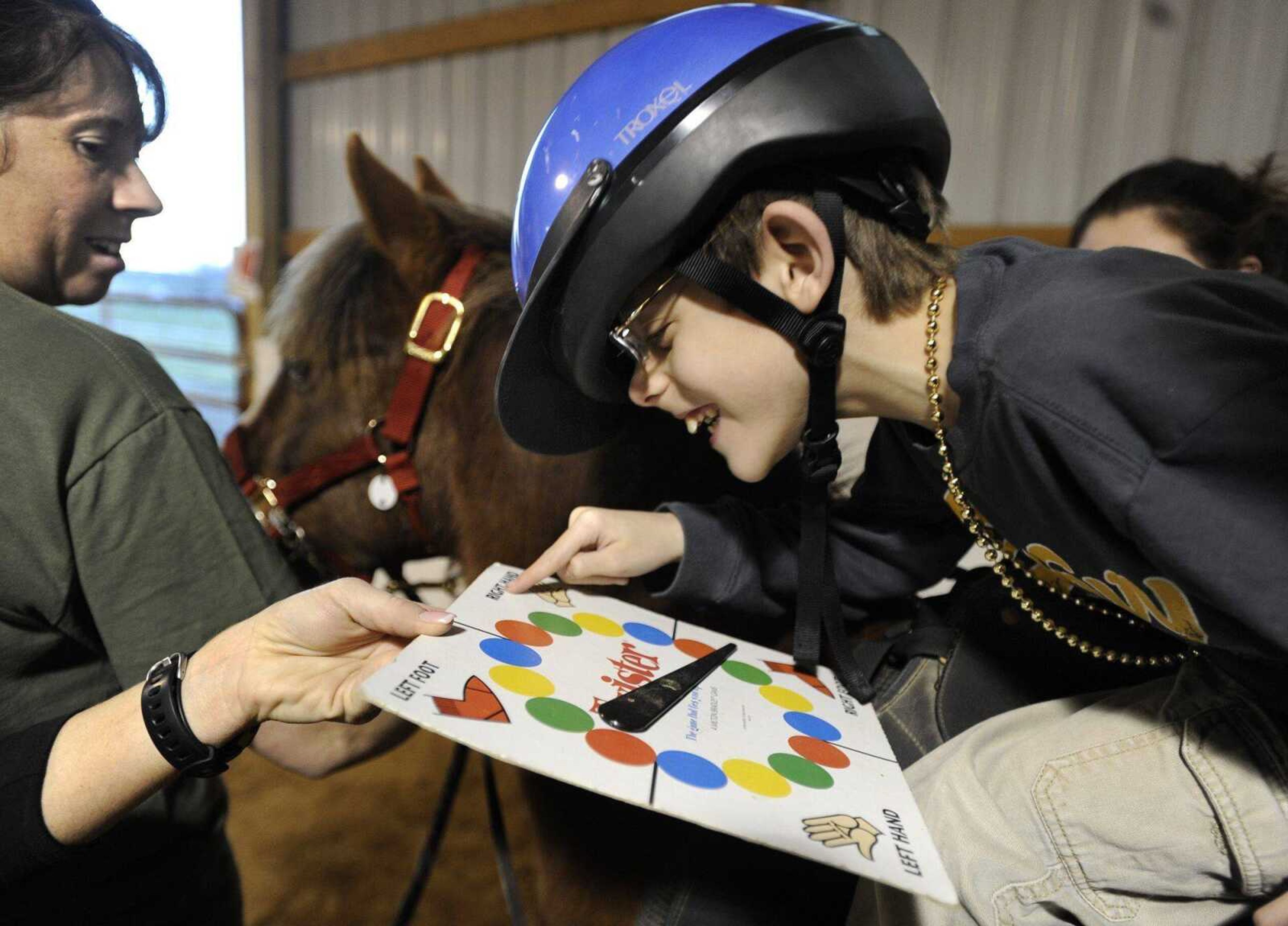 Landon Southard spins the wheel to choose a task during a lesson Thursday, Feb. 23, 2012 with Mississippi Valley Therapeutic Horsemanship. (Fred Lynch)