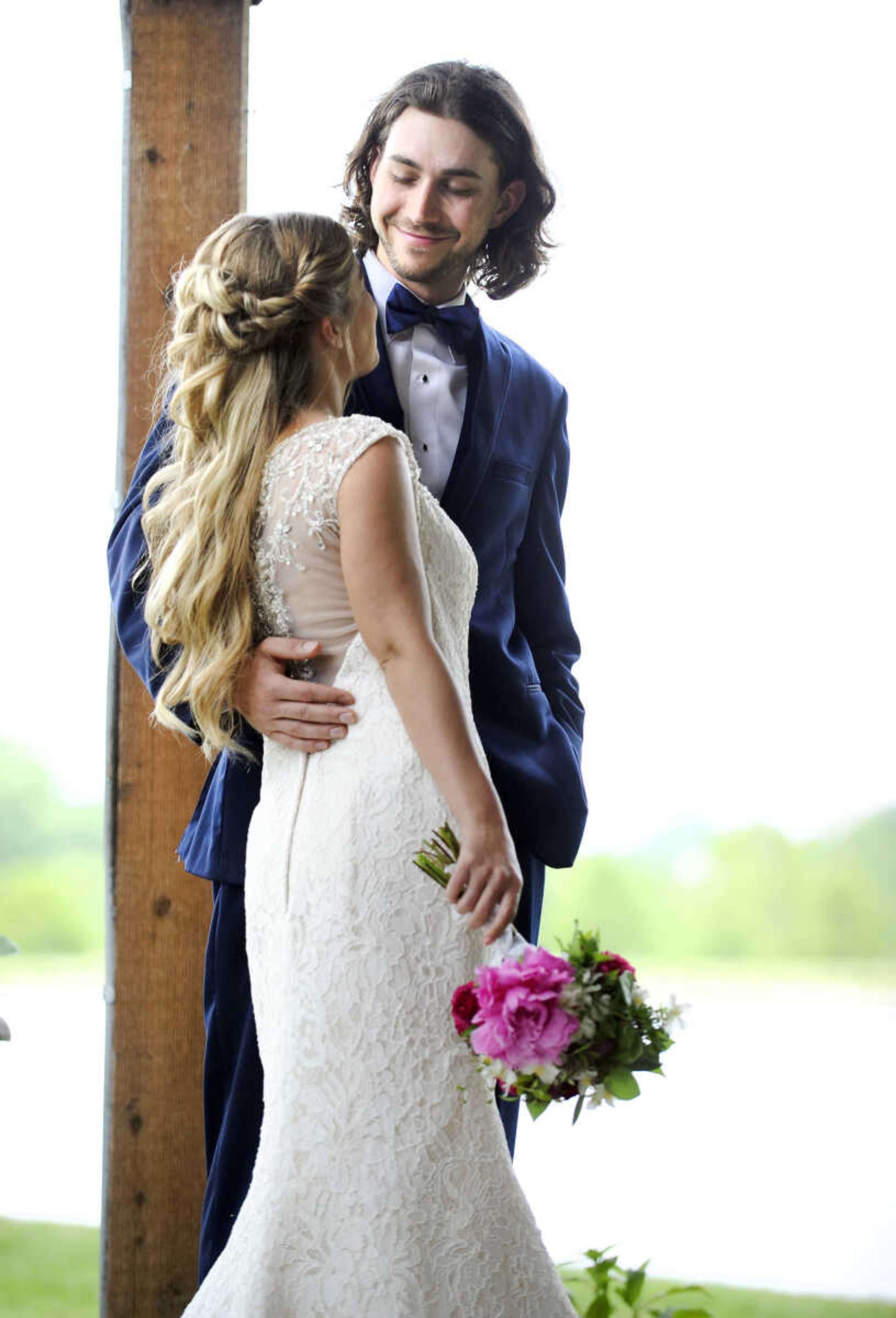 On Lydia:  Alfred Angelo fit-and-flare gown in ivory and champagne lace with crystal and rhinestone buttons adorning a sheer back. Available at Weddings and Parties Complete in Jackson.


On Evan: Navy Sterling slim fit wedding suit by Michael Kors with navy plaid bow tie. Provided by Jim's Formal Wear and available at Garber's Men's Wear in Cape Girardeau.