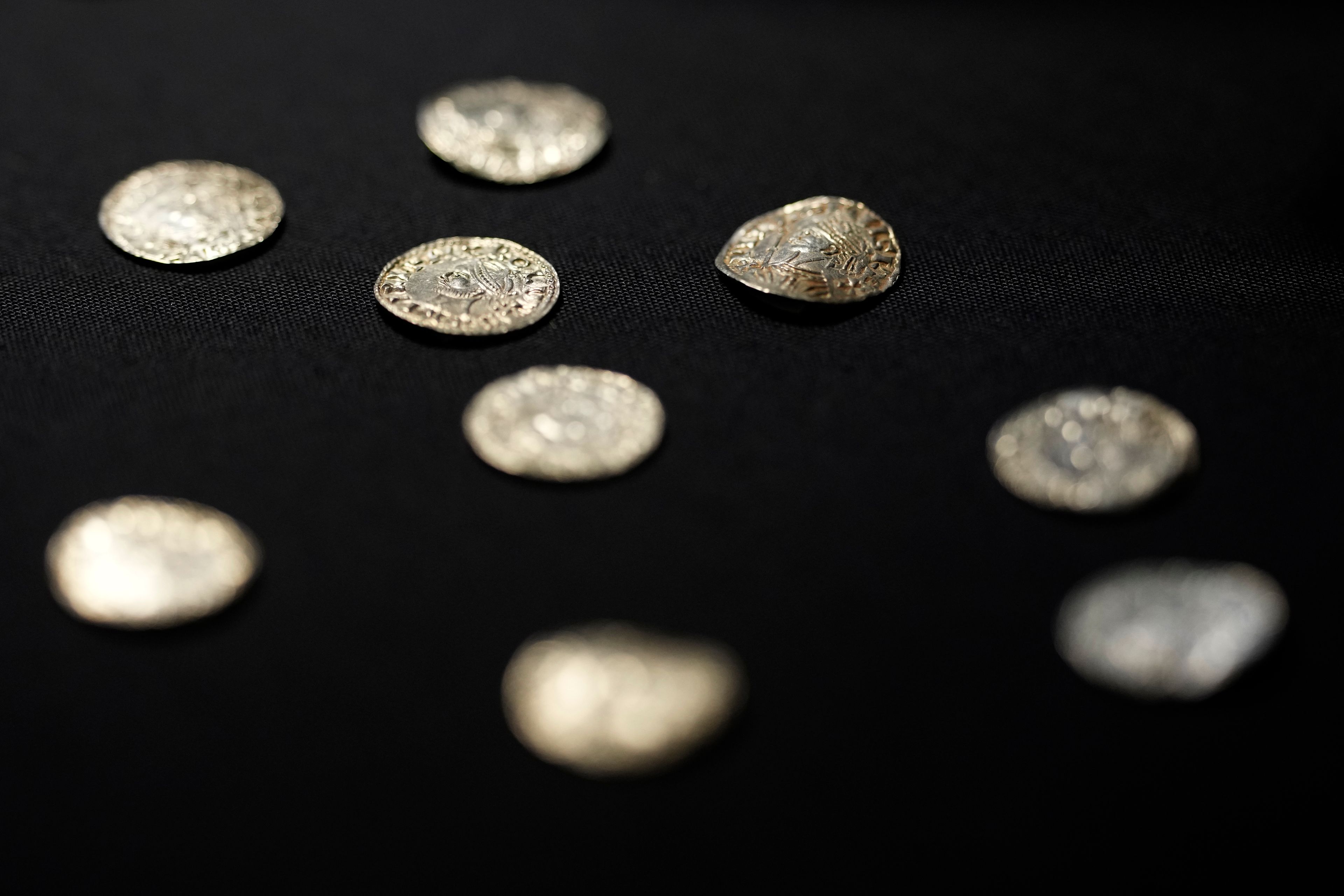 A selection of coins dating from the time around the Norman Invasion of Britain in 1066, which are part of the Chew Valley Hoard of 2,584 coins, on display at the British Museum in London, Tuesday, Oct. 22, 2024, the hoard is valued at £4.3 million pounds, (US$5.58 million), a record find. (AP Photo/Alastair Grant)