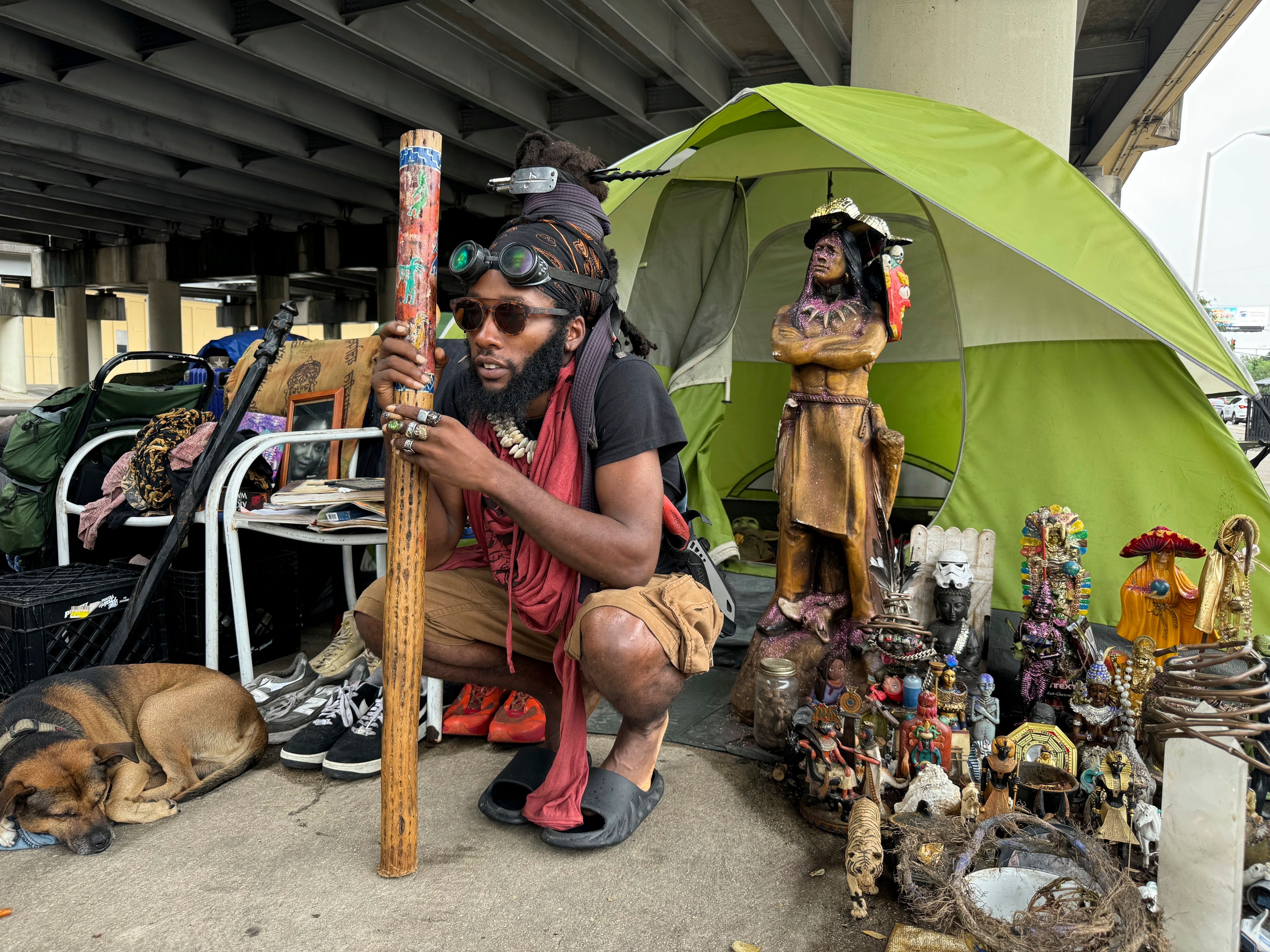 Ronell King, 32, unhoused, plans to hunker down in his tent under an overpass Tuesday, Sept. 10, 2024, in New Orleans, rather than go to an emergency shelter set up by the city in anticipation of Tropical Storm Francine. (AP Photo/Jack Brook)