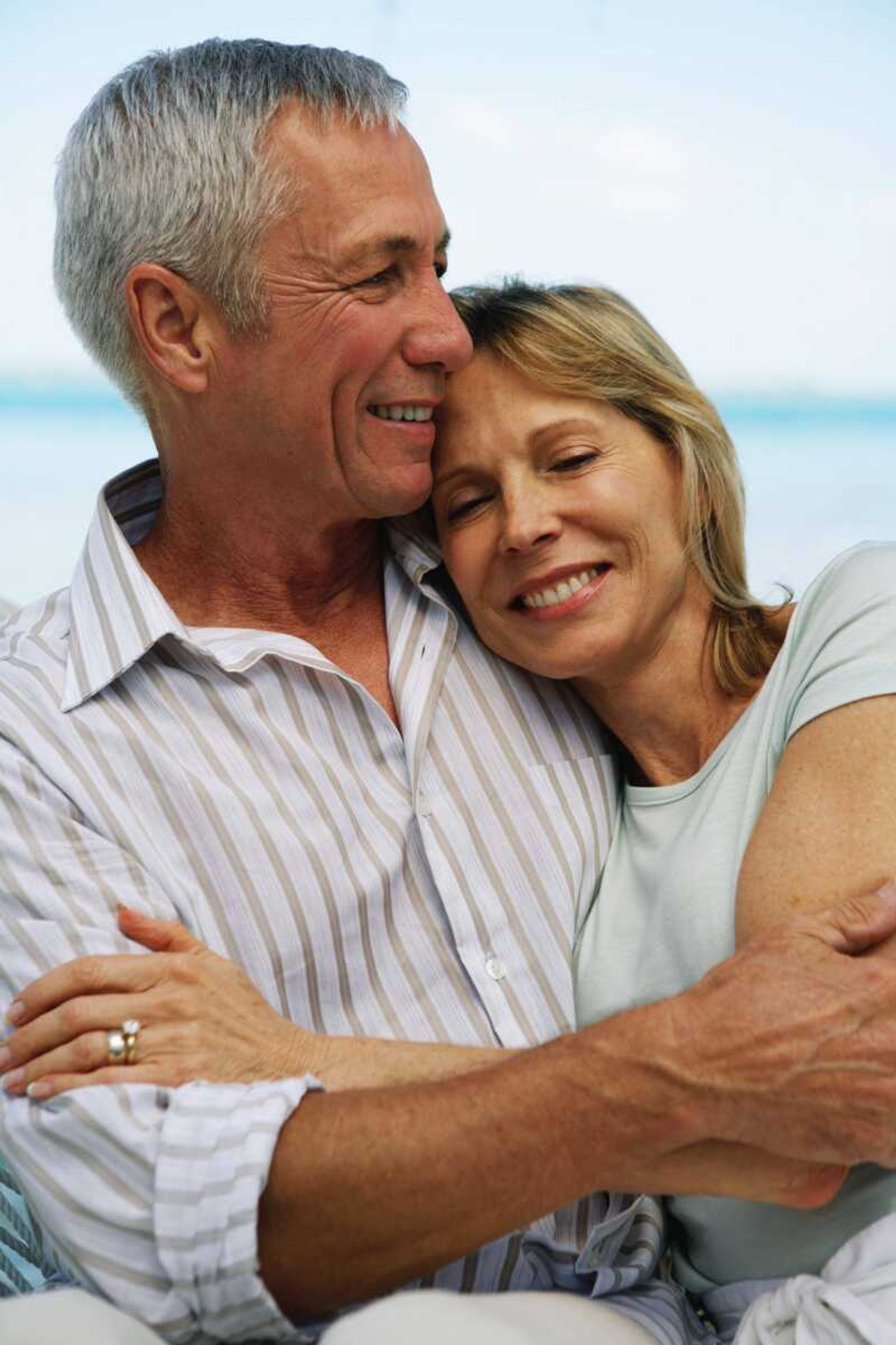 Senior couple embracing, smiling, close-up