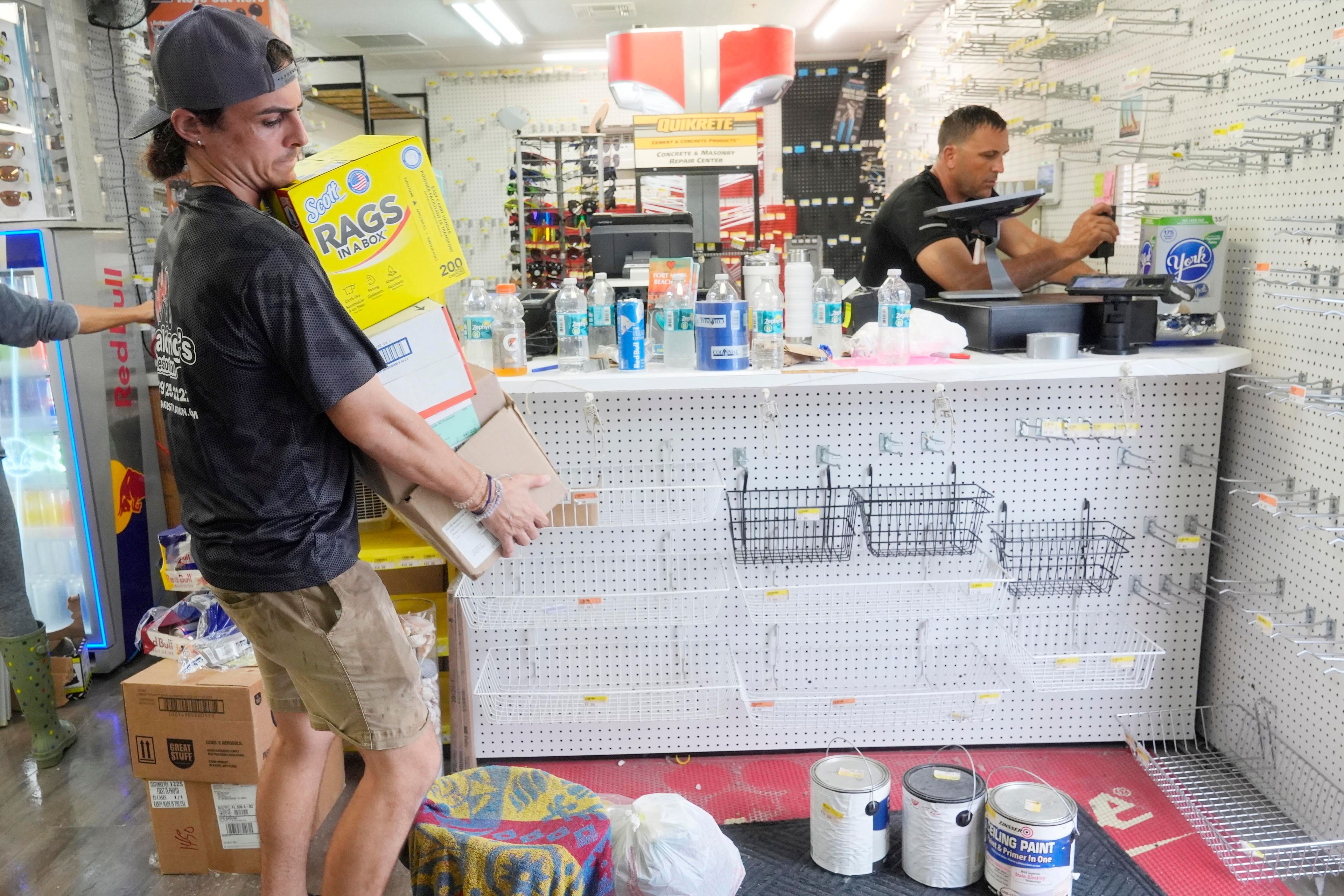 Employees at The Goodz hardware store, remove all the merchandise in advance of Hurricane Milton, Monday, Oct. 7, 2024, in Fort Myers Beach, Fla. (AP Photo/Marta Lavandier)