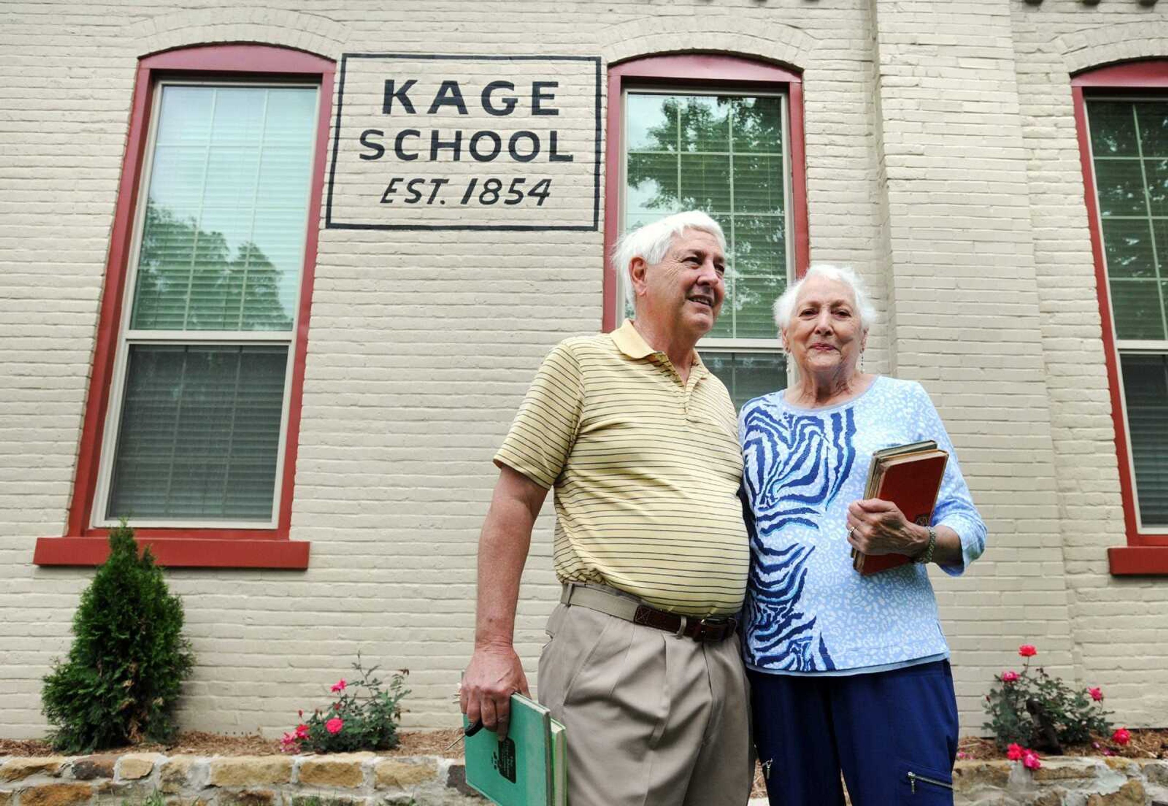 Keith Deimund and his older sister Barbara Deimund Swink, stand outside the newly renovated Kage School, Sunday, May 10, 2015. Swink attended Kage from 1936 to 1938 and Deimund attended the school from 1946-1948. (Laura Simon)