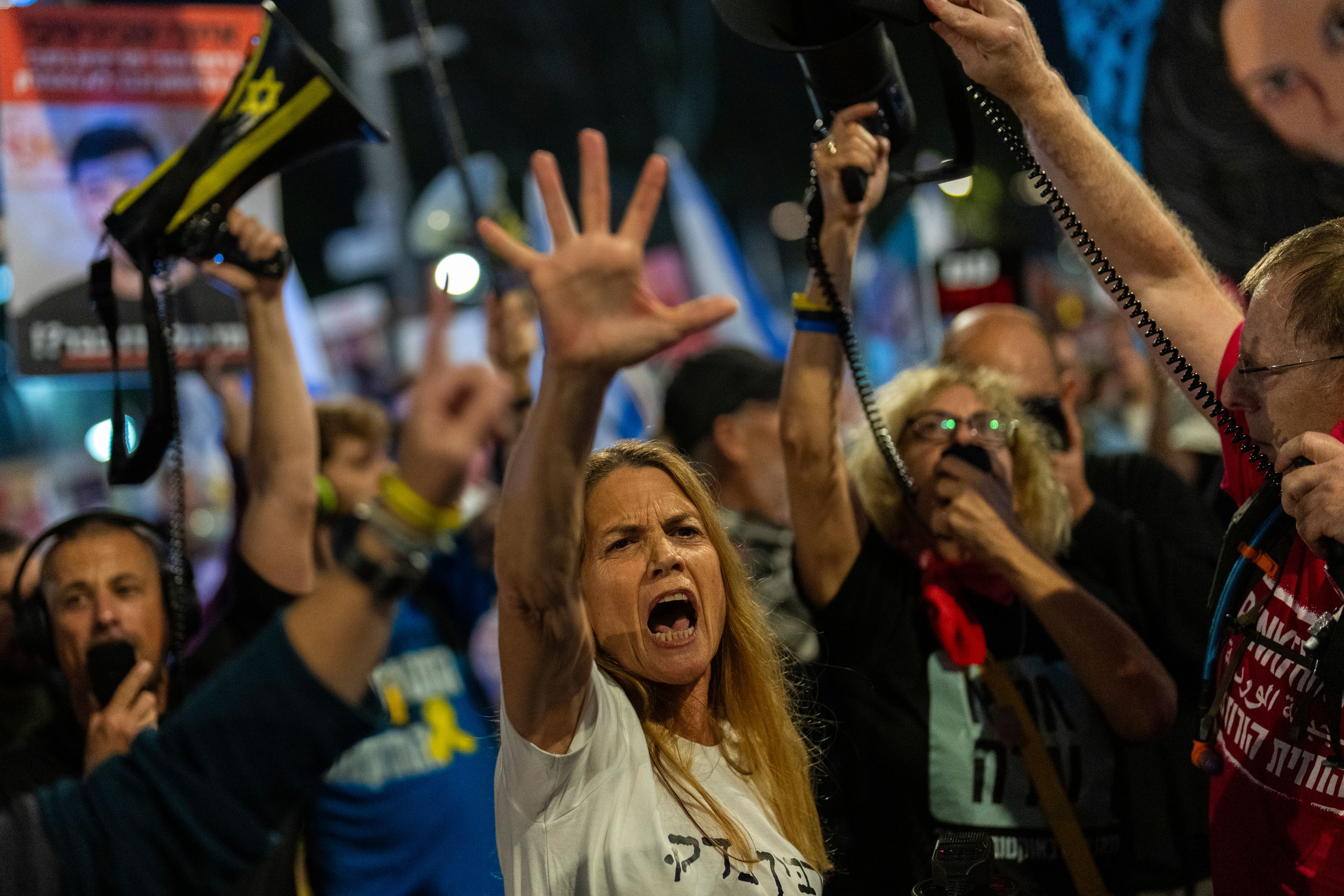 People shout slogans during a protest against Prime Minister Benjamin Netanyahu's government and call for the release of hostages held in the Gaza Strip by the Hamas militant group, in Tel Aviv, Israel, Saturday, Nov. 16, 2024. (AP Photo/Francisco Seco)