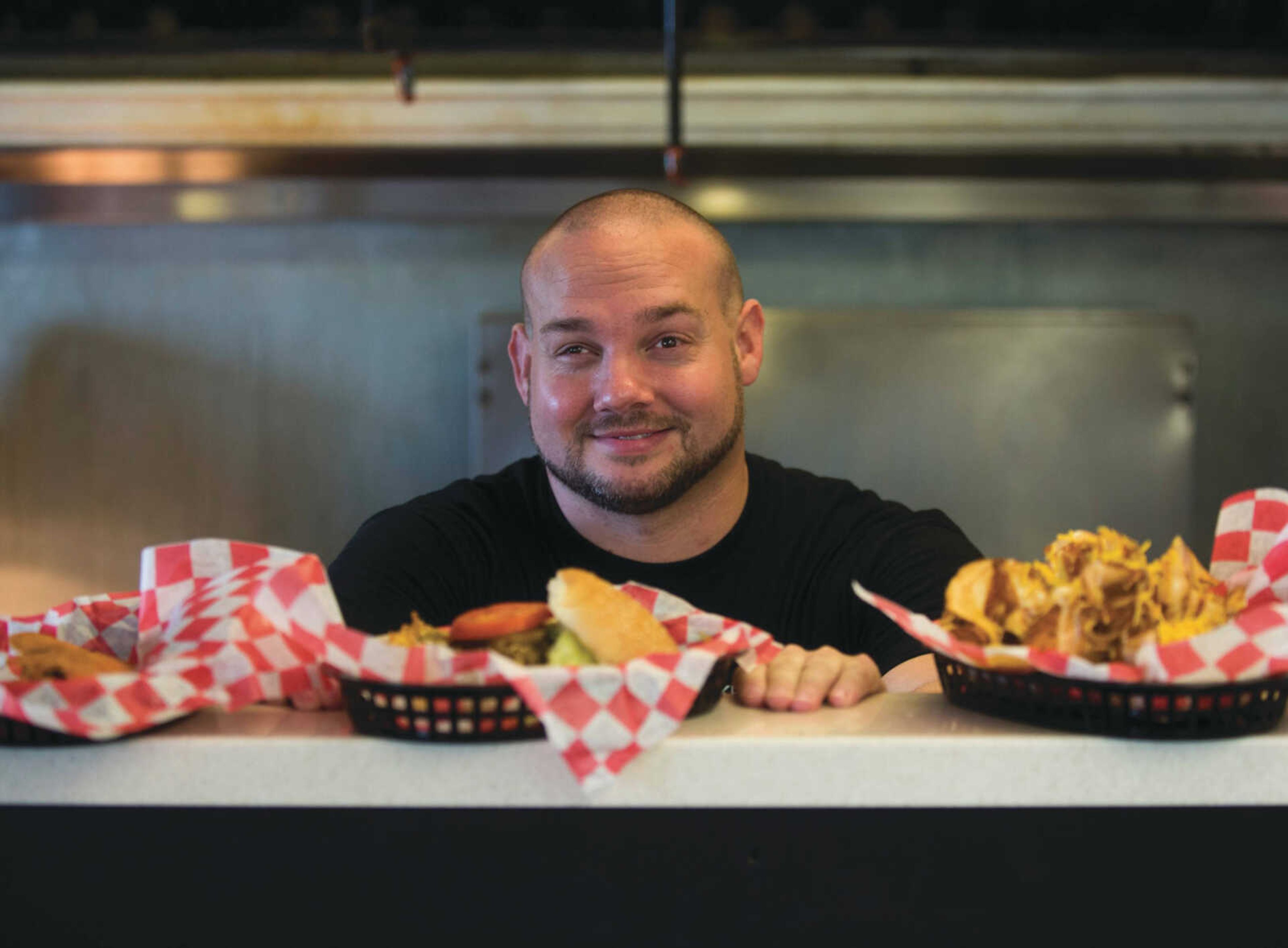 BEN MATTHEWS ~ bmatthews@semissourian.com Jesse Stuart stands in the kitchen window Sept. 18, 2017 at Kenny's Flippin' Burgers in Chaffee.