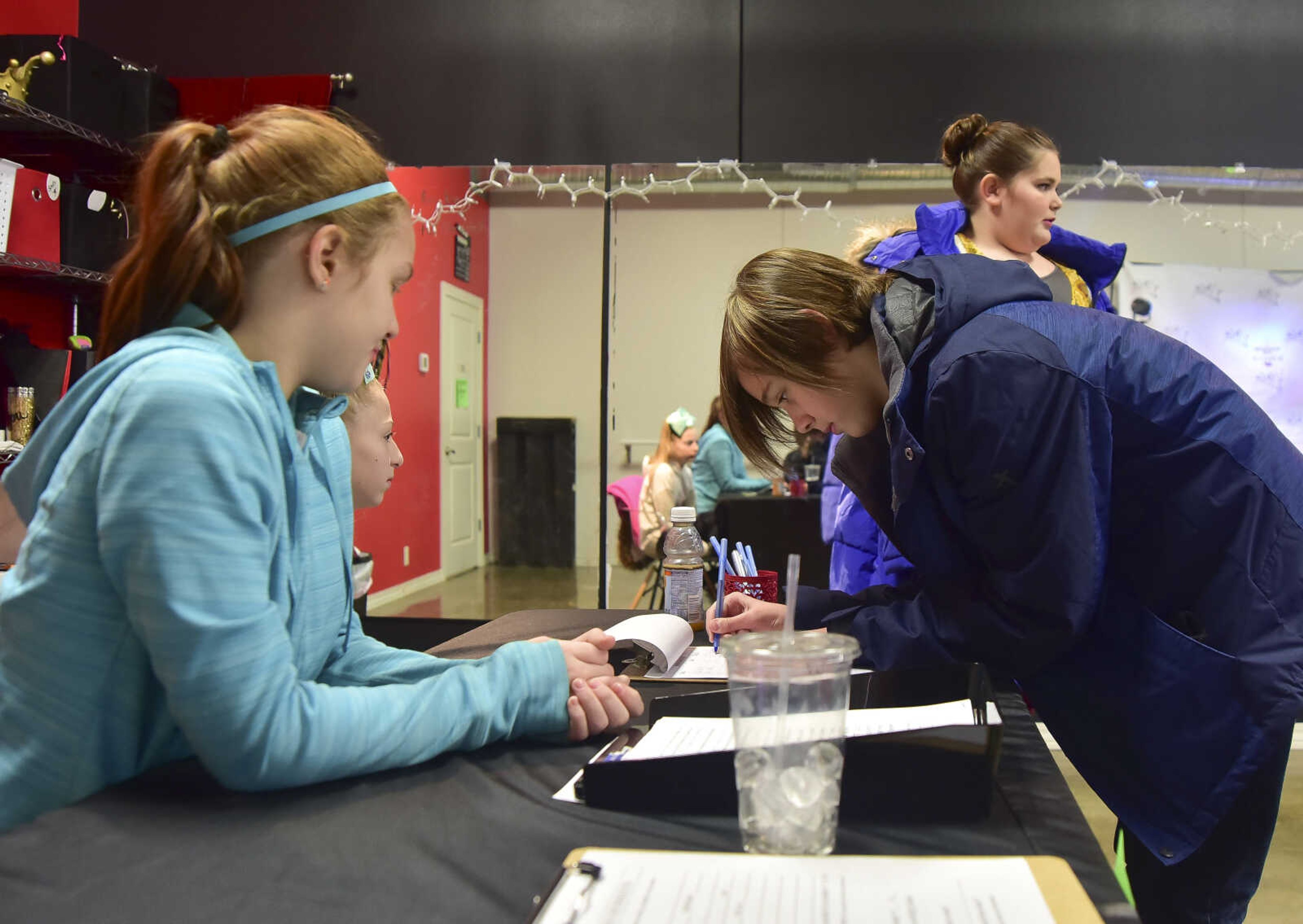 Sam Helle, 12, and Allie Helle, 11, sign up for auditions for the Wizard of Oz at On Cue Performing Arts Studio Saturday, Jan. 7, 2017 in Cape Girardeau.