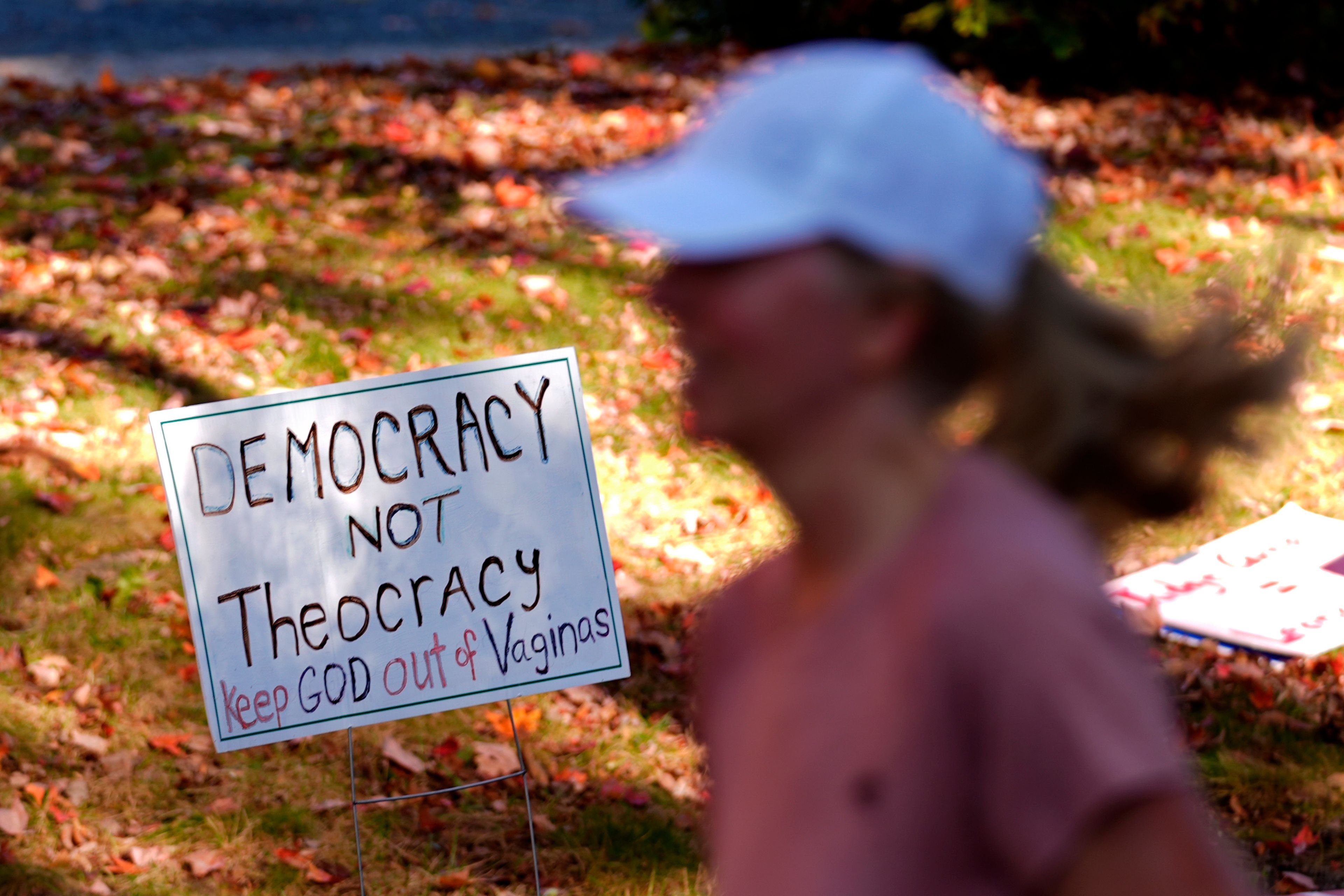 A sign is seen during a protest near the home of Leonard Leo during the Mount Desert Island Marathon, Sunday, Oct. 20, 2024, in Northeast Harbor, Maine. (AP Photo/Robert F. Bukaty)