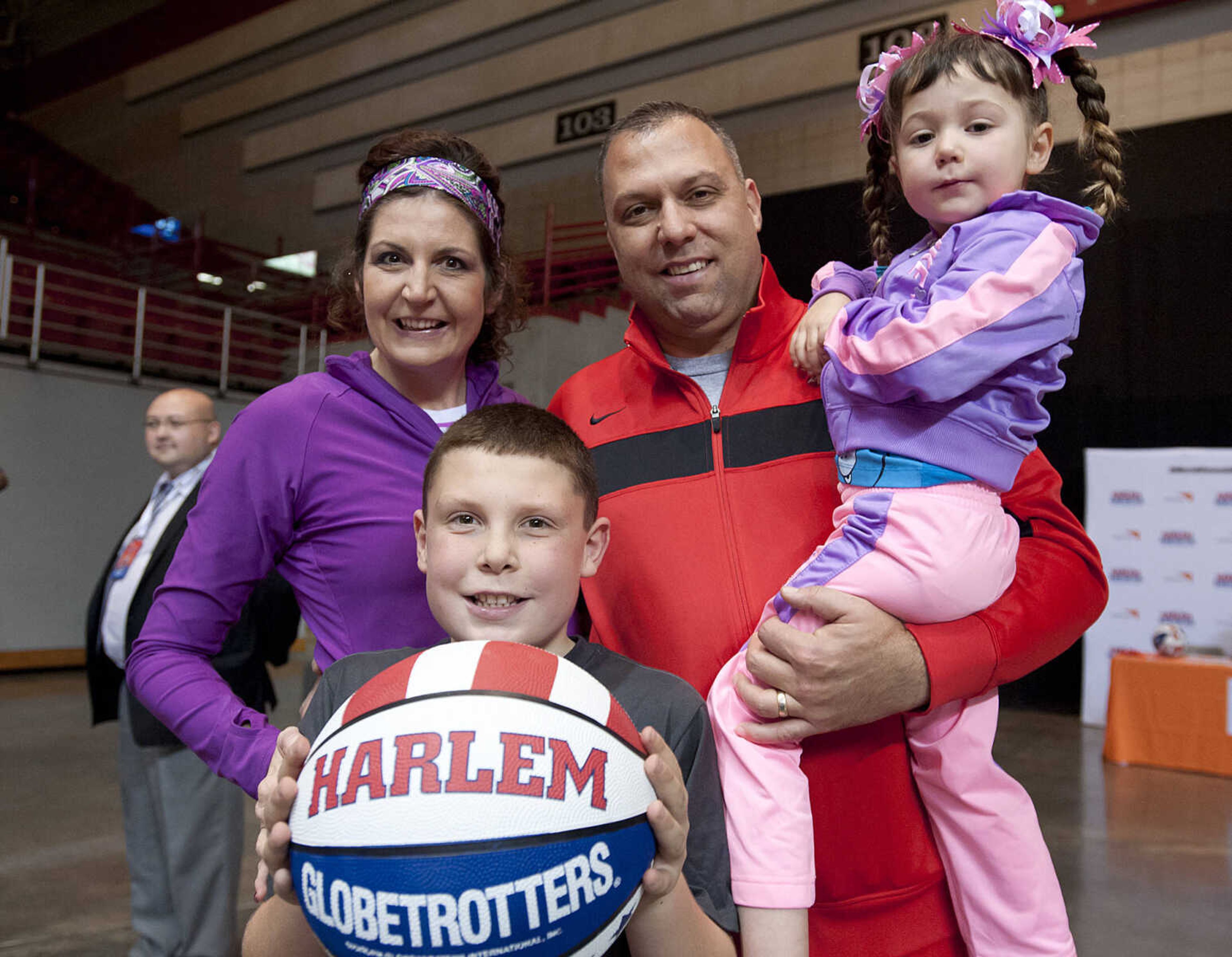 Sarah, left, and Jeff Honza with Ben, 9, and Alaina, 4, at the Original Harlem Globetrotters' performance Monday, Jan. 13, at the Show Me Center.