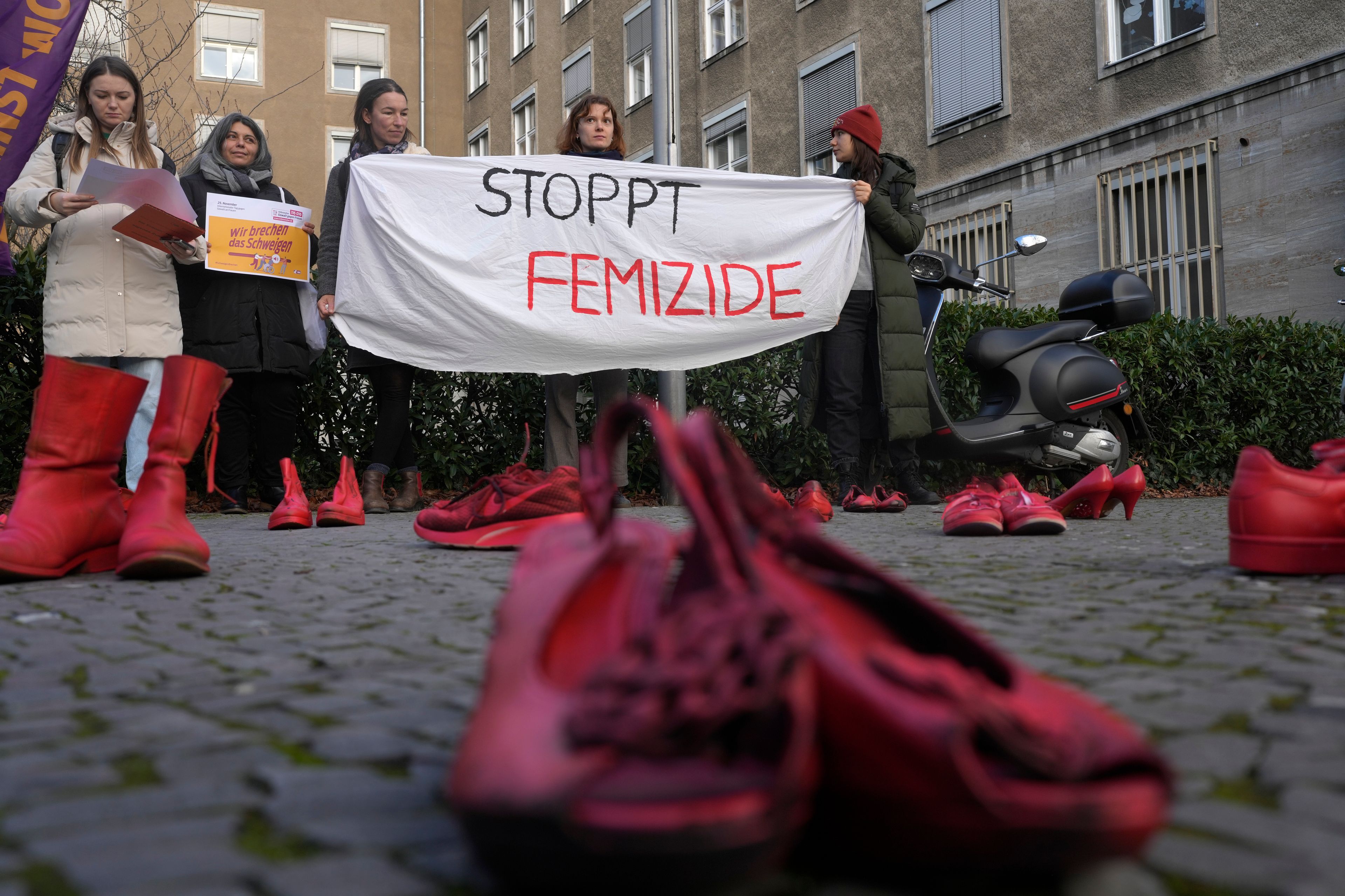 Red shoes placed on the ground as a symbol against the violence on women during a rally marking the International Day for the Elimination of Violence Against Women in Berlin, Germany, Monday, Nov. 25, 2024. (AP Photo/Markus Schreiber)