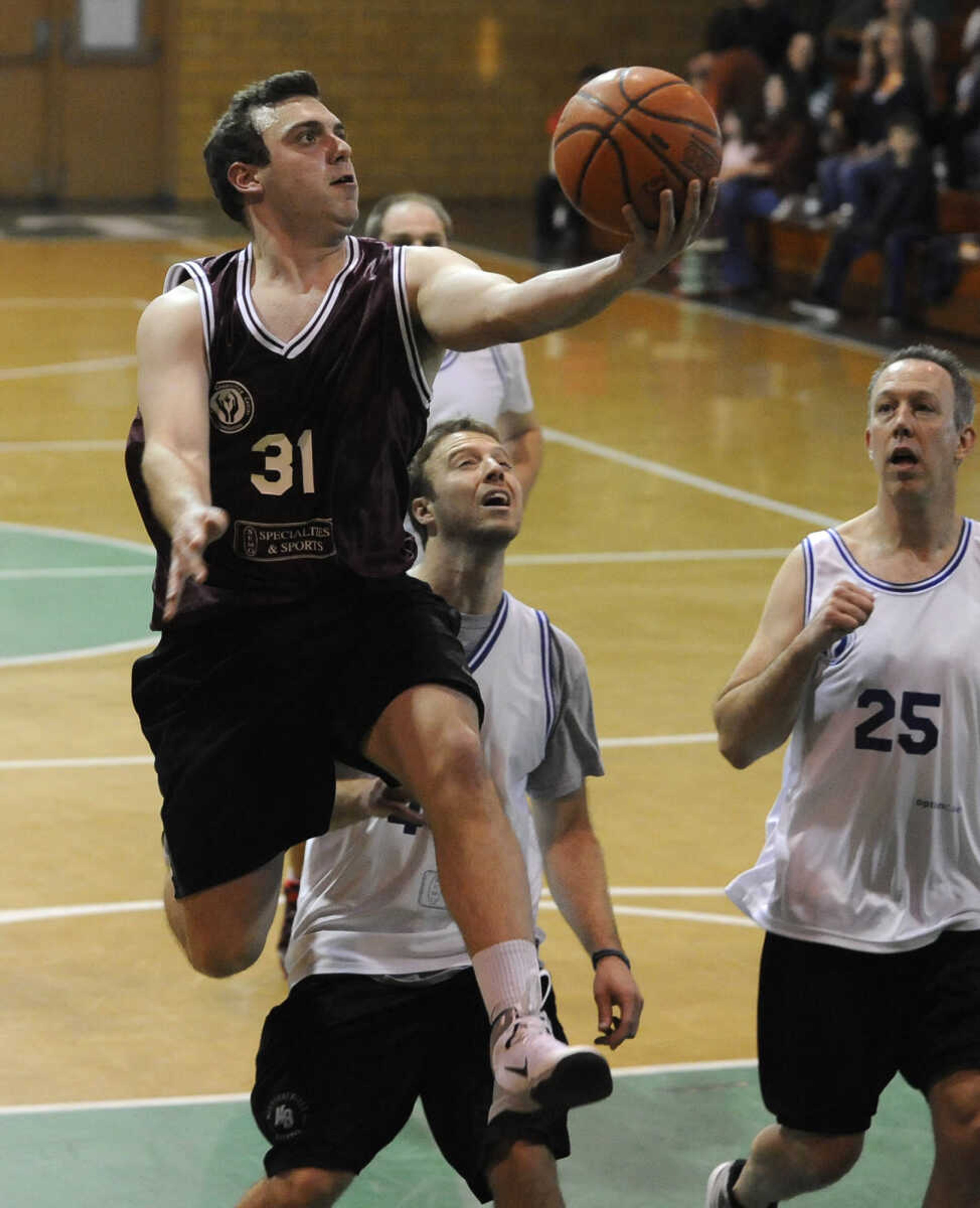 FRED LYNCH ~ flynch@semissourian.com
The Lawyers' Jake "The Ringer" Luria drives to the basket past the Doctors' Ryne "I See You" Wood and Mark "Poison Control" Meadors during the Doctors vs. Lawyers Basketball Showdown on Saturday, March 22, 2014 at the DePaul Center in Cape Girardeau.