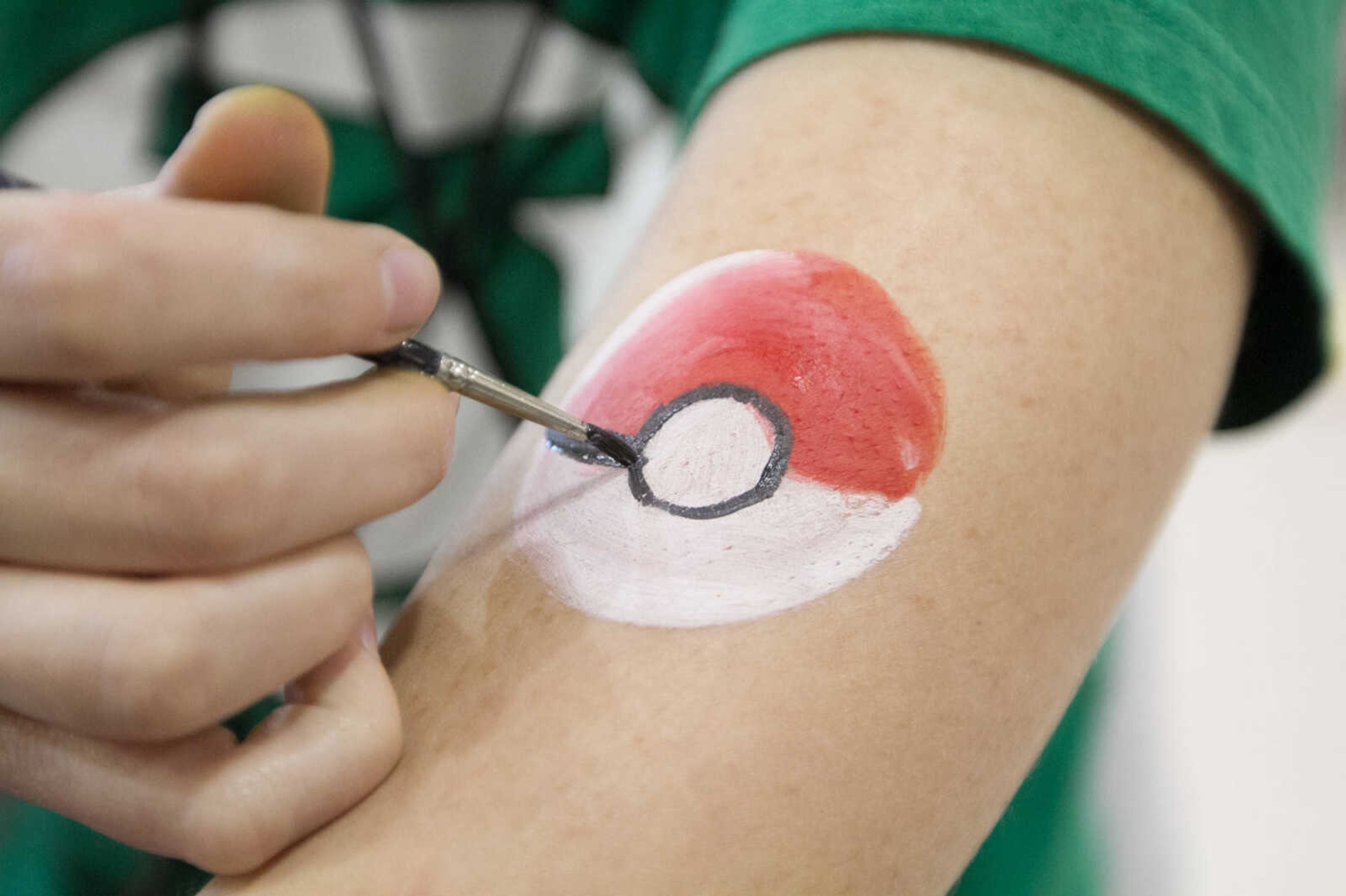 GLENN LANDBERG ~ glandberg@semissourian.com


Tessa Valleroy paints a pokeball on her arm between customers at a face painting booth during Cape Comic Con Friday, April 17, 2015 at the Osage Centre.