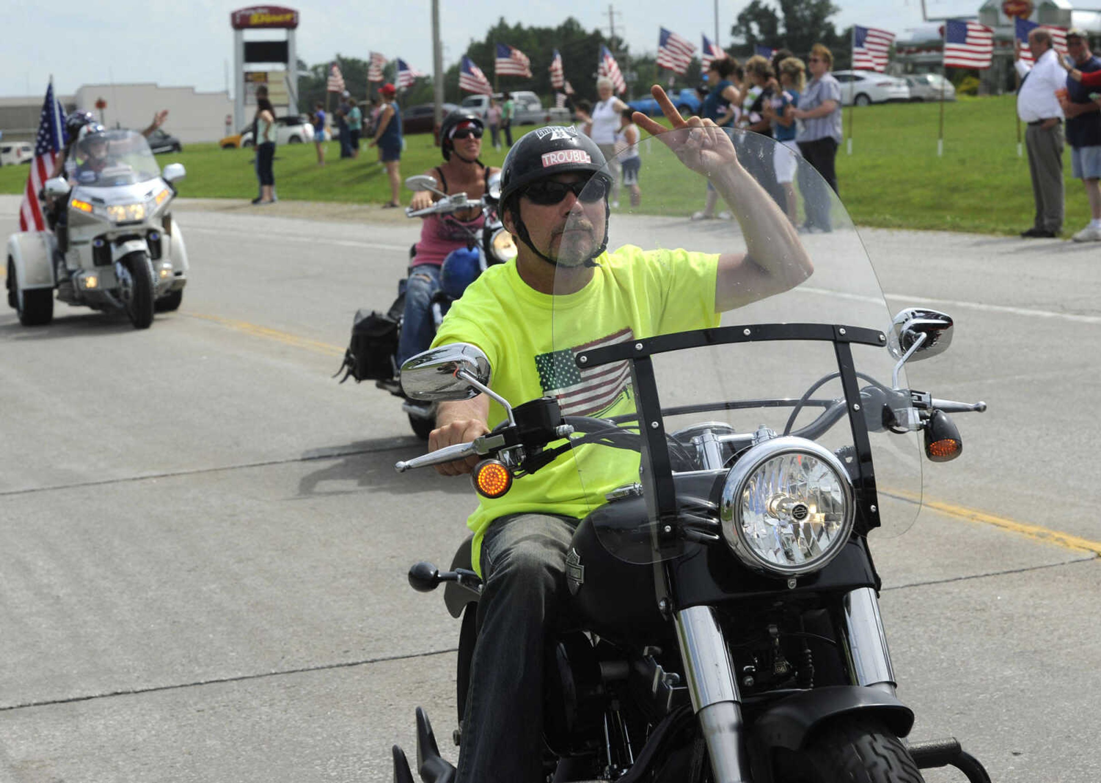 Motorcyclists ride with The Wall That Heals on Tuesday, June 17, 2014 in Perryville, Mo.