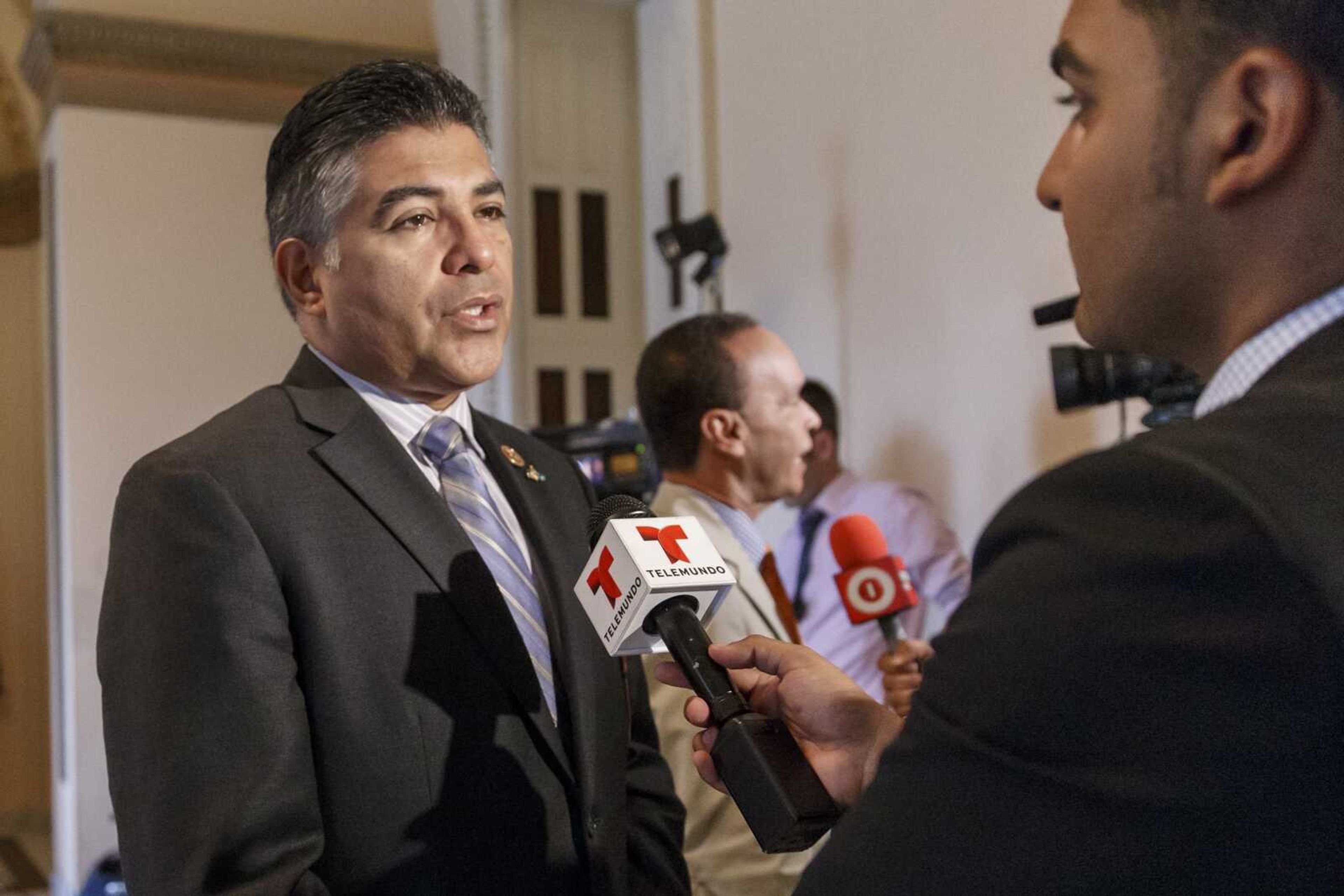 Congressional Hispanic Caucus members Rep. Tony Cardenas, D-Calif., left, and Rep. Luis V. Gutierrez, D-Ill., center, speak with Spanish-language TV reporters in 2014 on Capitol Hill in Washington. Joe Biden's presidential bid got a boost Monday from one of the leading Latinos in Congress, with the chairman of the Hispanic Caucus' political arm endorsing the former vice president as Democrats' best hope to defeat President Donald Trump.