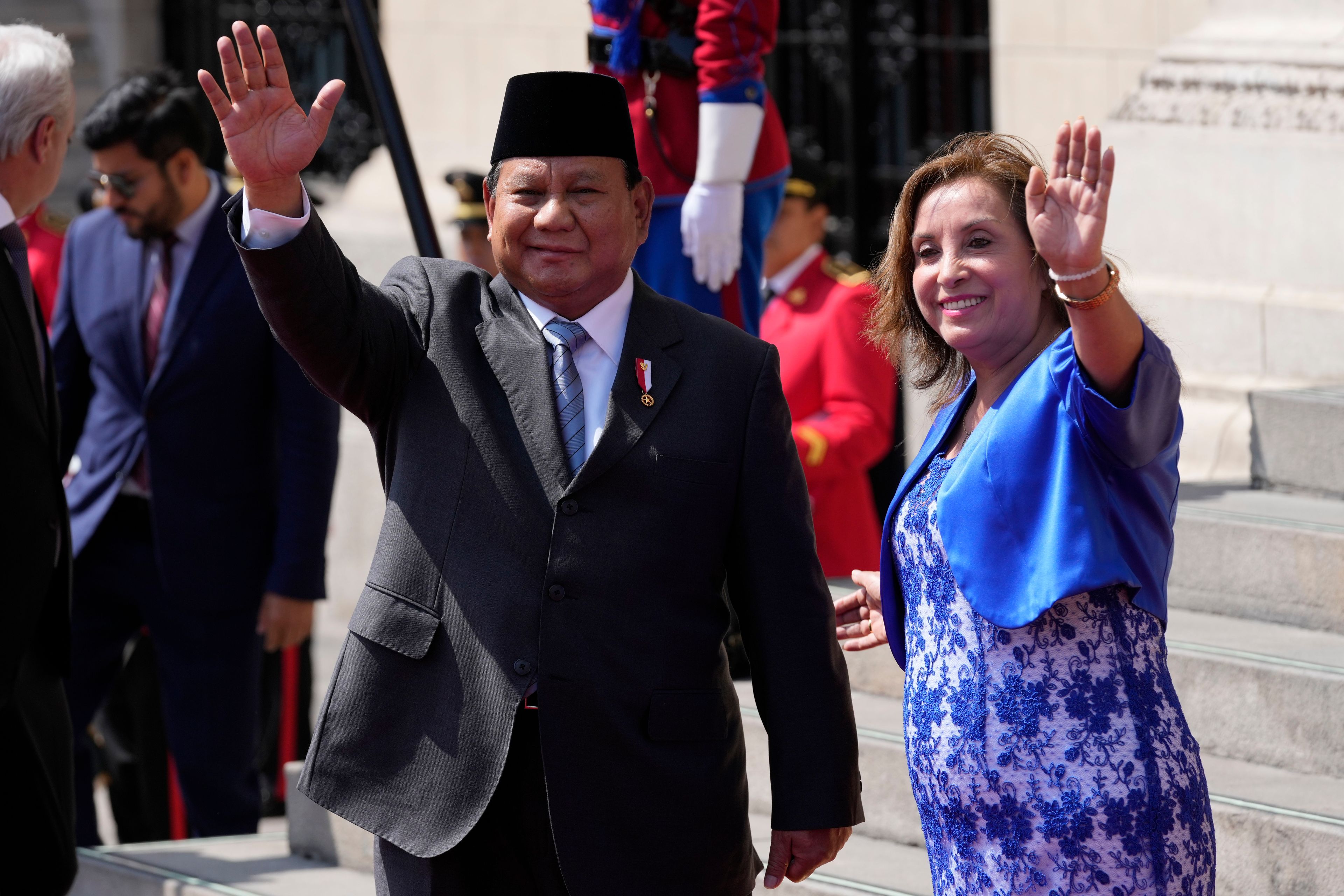 Indonesian President Prabowo Subianto, left, and Peru's President Dina Boluarte pose for photos on the steps of the government palace during a welcoming ceremony at the government palace in Lima, Peru, Thursday, Nov. 14, 2024, on the sidelines of the Asia-Pacific Economic Cooperation (APEC) summit. (AP Photo/Fernando Vergara)