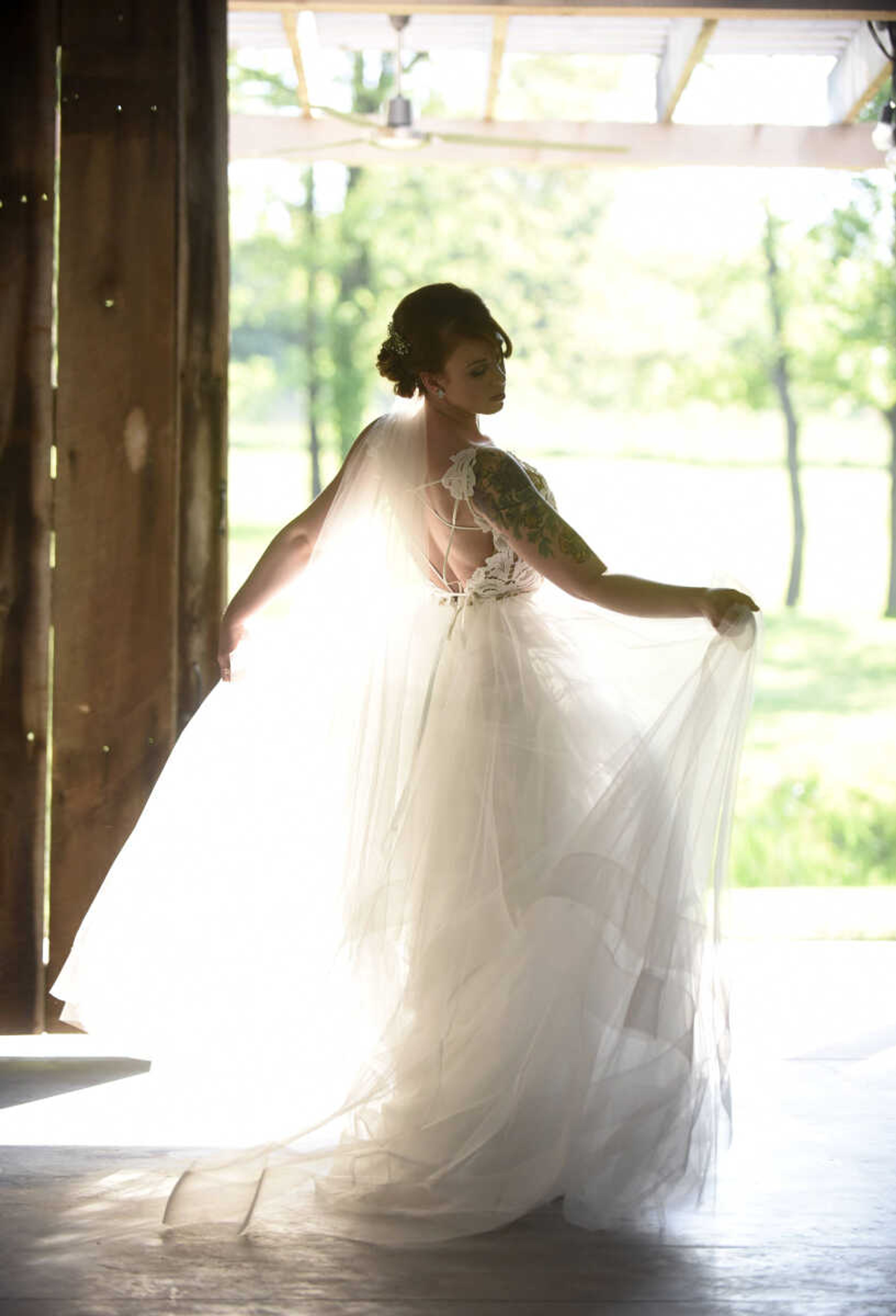 Blush by Hayley Paige: Style 1700 "Halo" 
Ivory lace and tulle bridal ball gown, scalloped V-neck bodice with low open back and strap detail, tiered tulle skirt with horsehair trim. Available at Magnolias Bridal Boutique in Cape Girardeau.