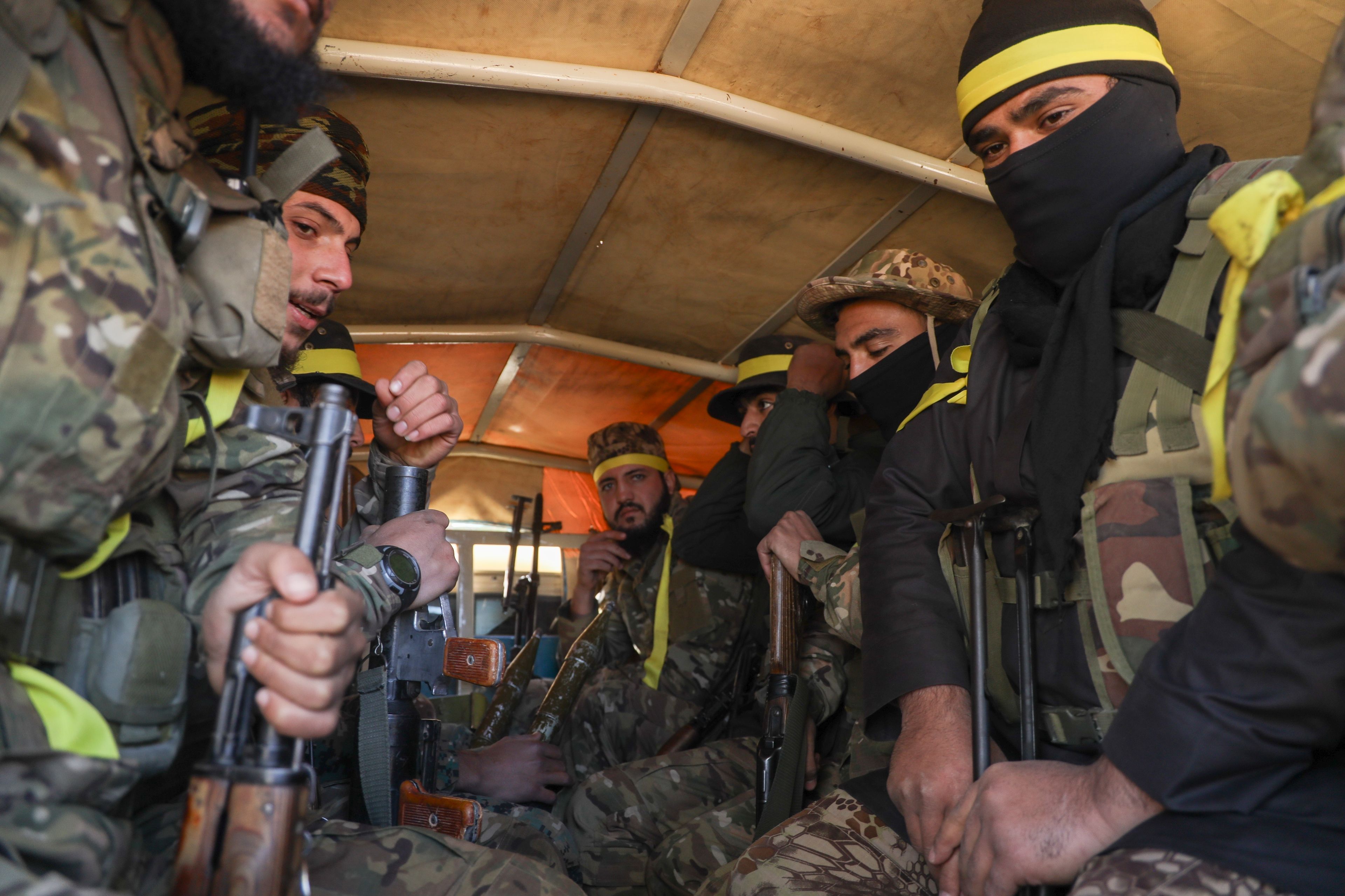 Syrian opposition fighters ride in a truck as they enter the village of Anjara, western outskirts of Aleppo, Syria, Thursday Nov. 28, 2024, part of their major offensive on government-controlled areas in the country's northwestern Syria. (AP Photo/Omar Albam)